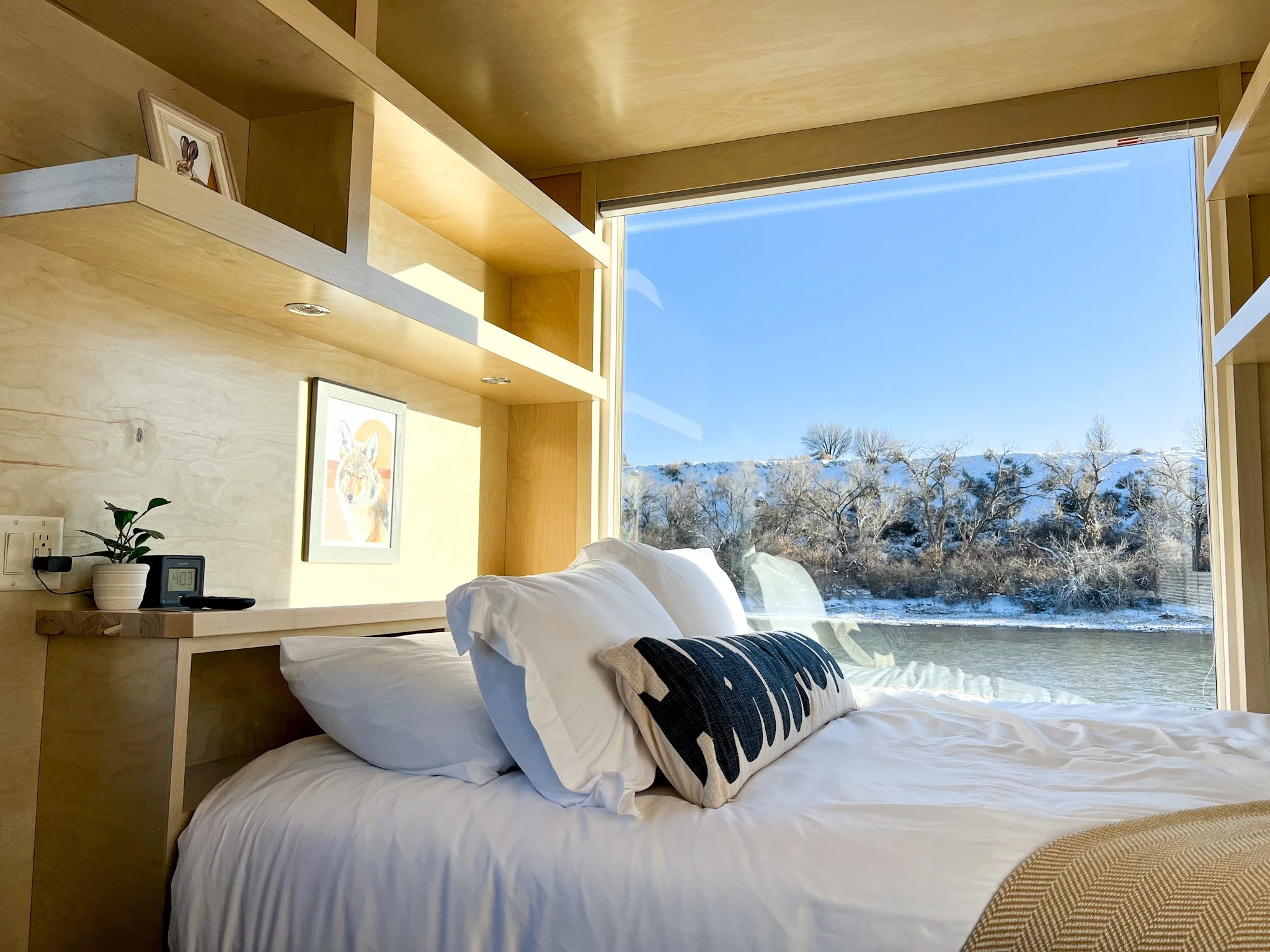 Tiny home with large window overlooking the river