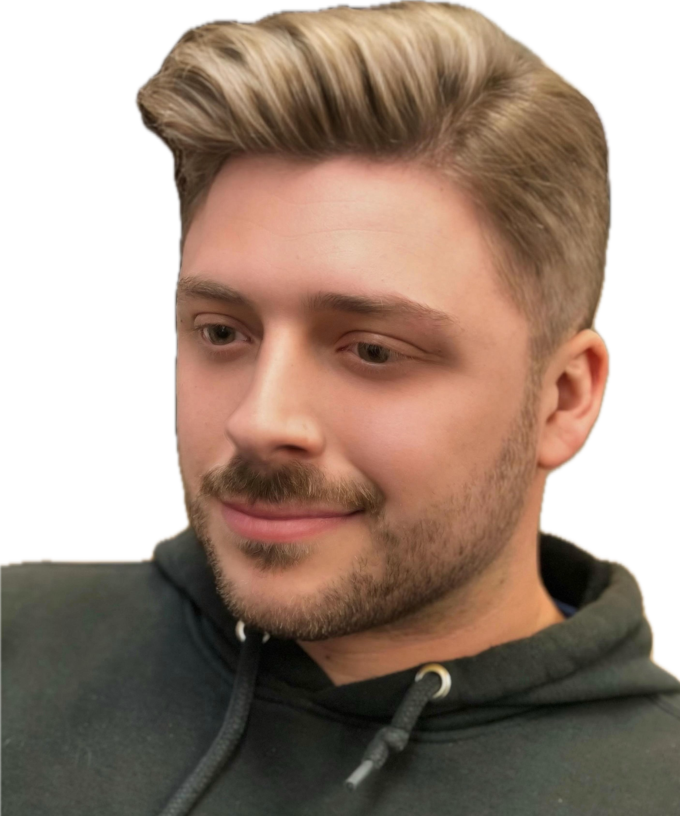 Close-up of a young man with blond hair, light facial hair, and wearing a black hoodie, looking slightly downward and smiling.