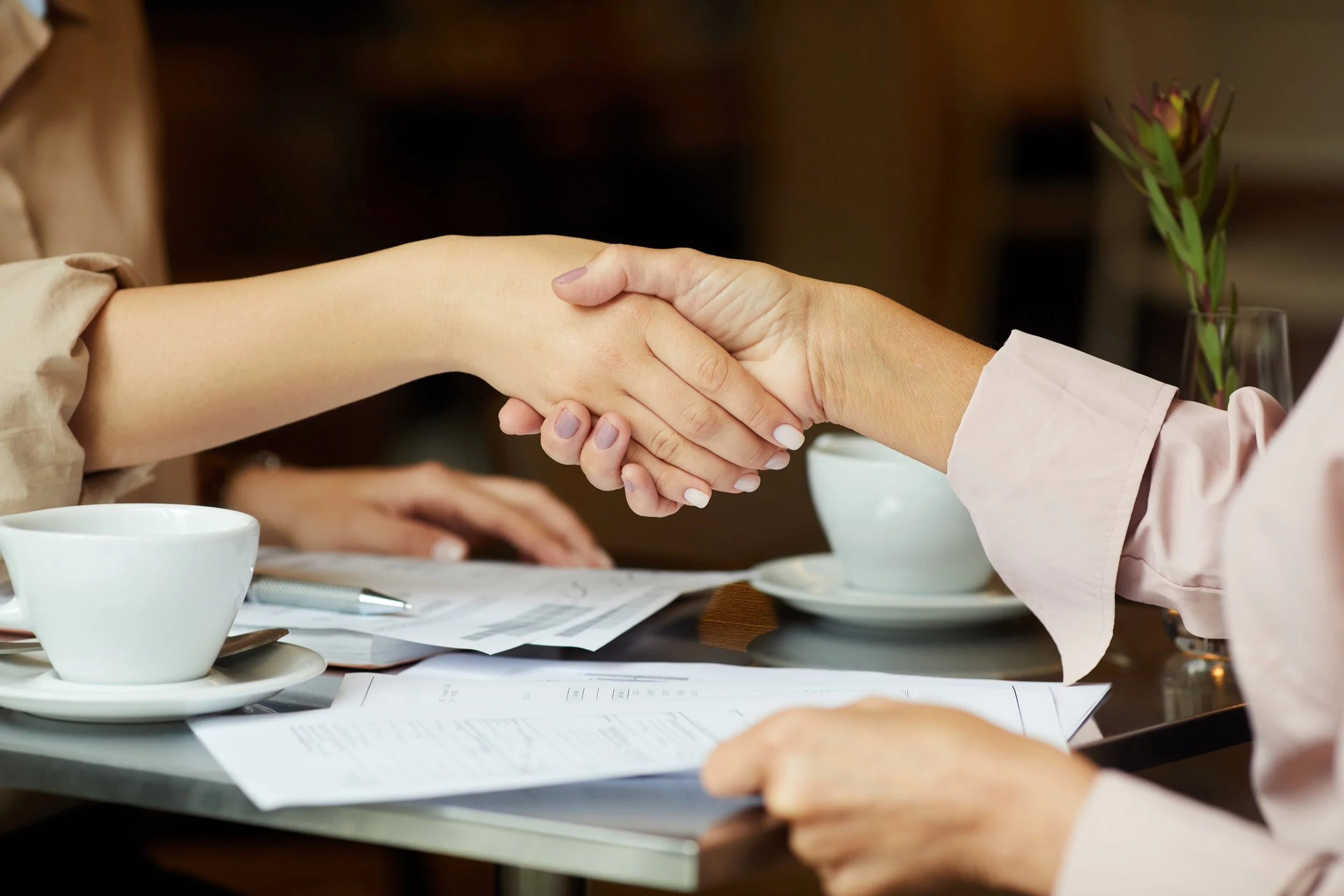 Title insurance for lenders - two women shaking hands - PV Settlement