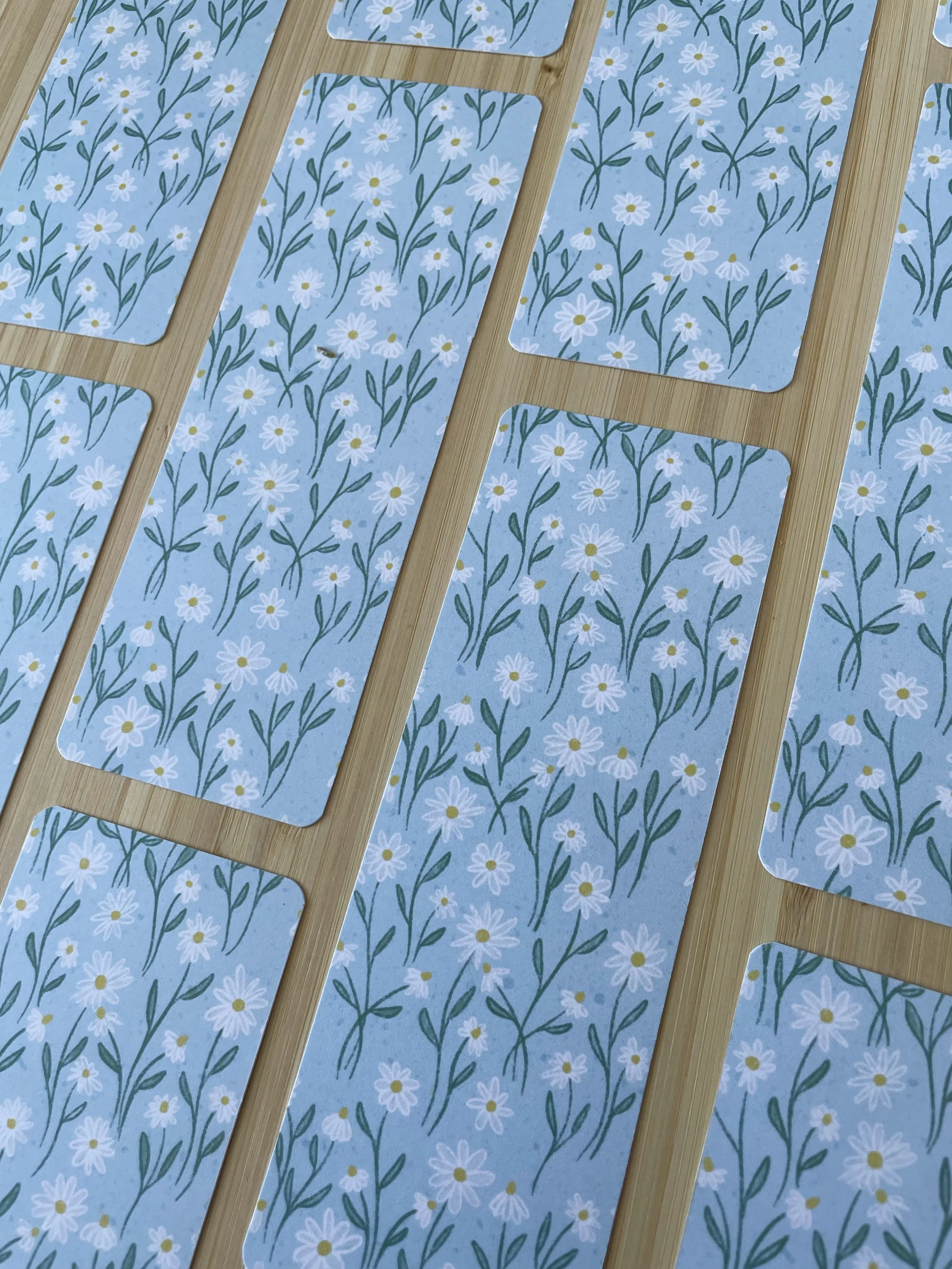 A collage of daisy bookmarks in a grid pattern.