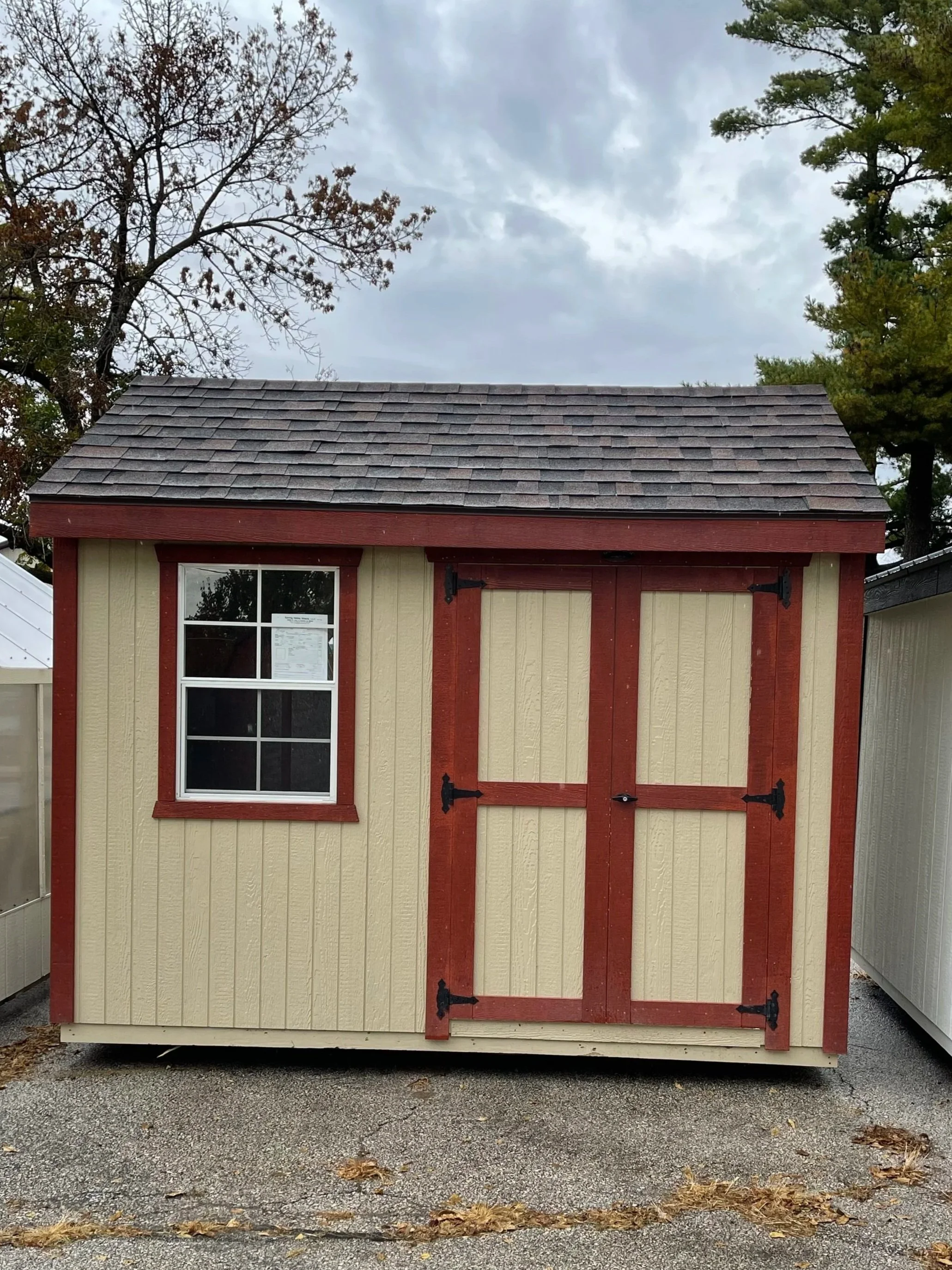 A-Frame Garden shed with shingles, double door, and window.