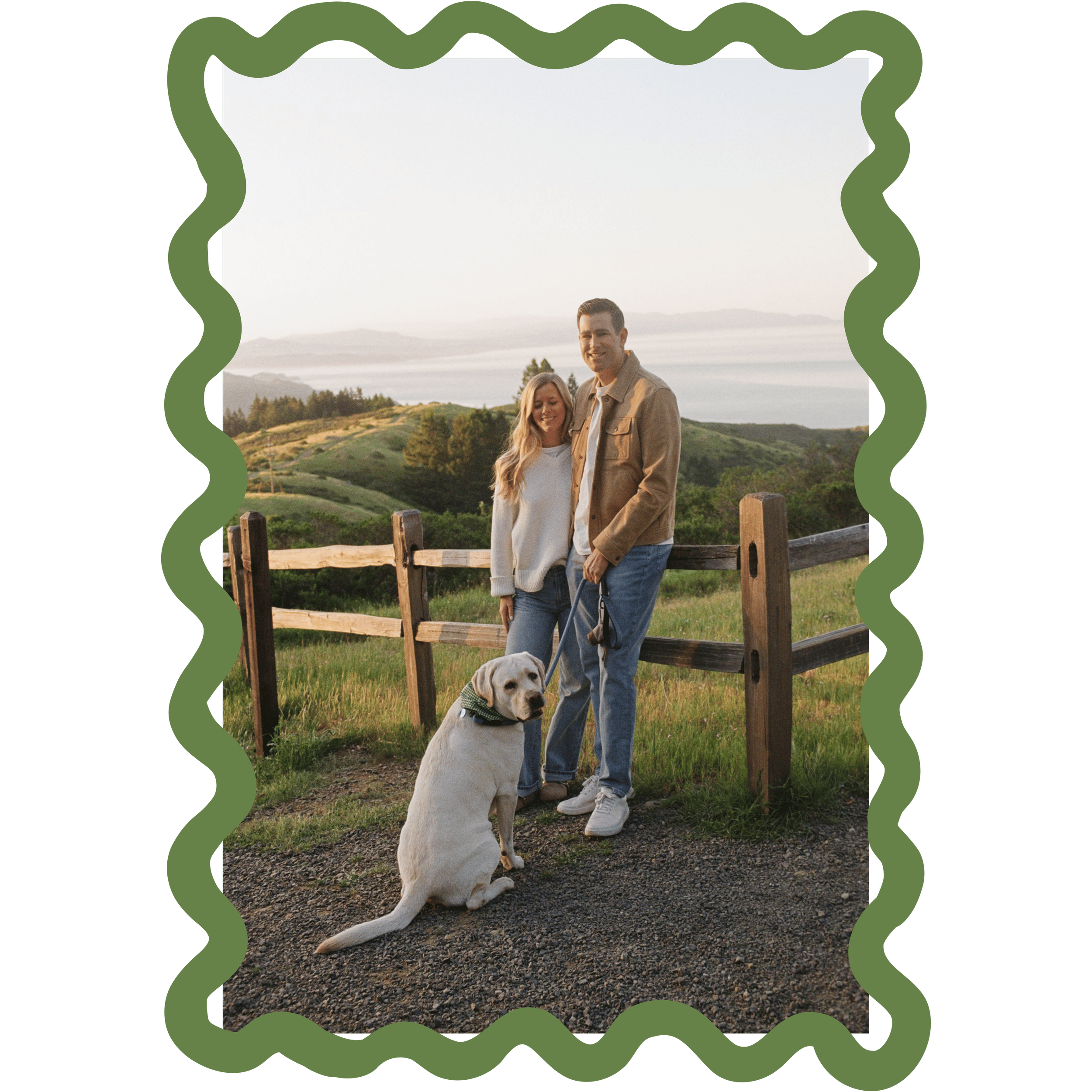 A couple standing outdoors with their golden retriever, marked by green decorative borders, in a scenic landscape at sunset.