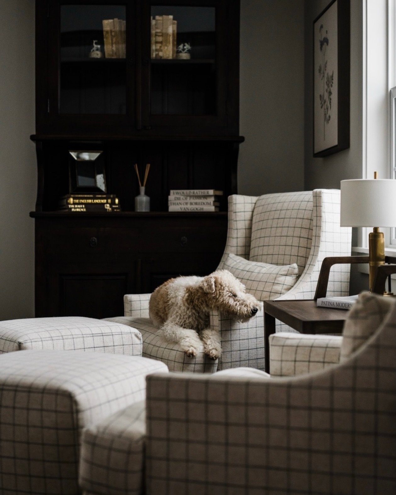 He is on a long awaited snow watch ❄️ Curled up in his favorite chair, keeping one eye on the window and the other on the possibility of a full Montana winter moment.

This cozy corner is made even more special with custom furniture designed for real