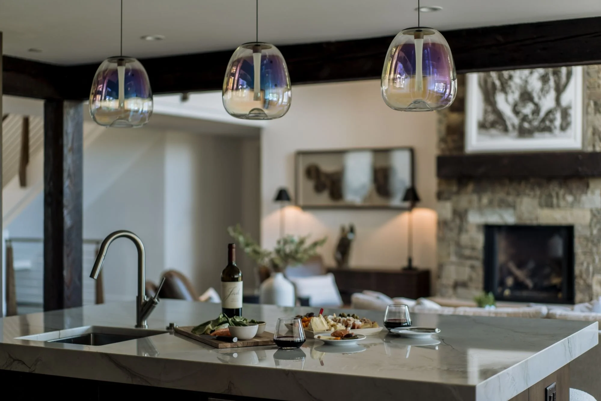 Three people reviewing architectural blueprints and samples on a wooden table in a design studio.