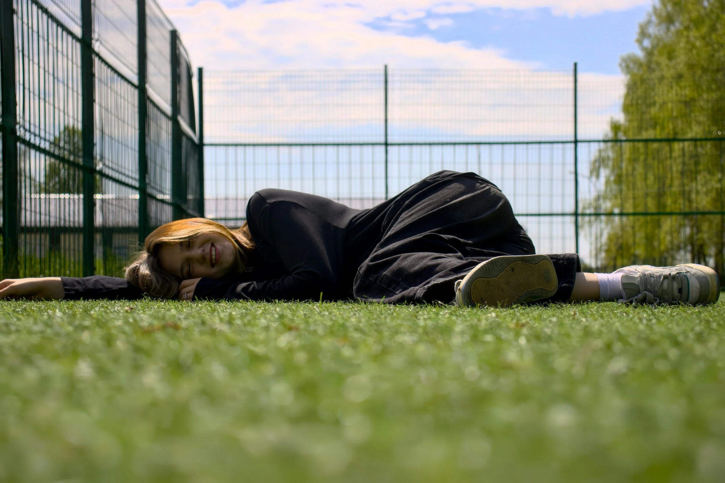 woman laying on the grass