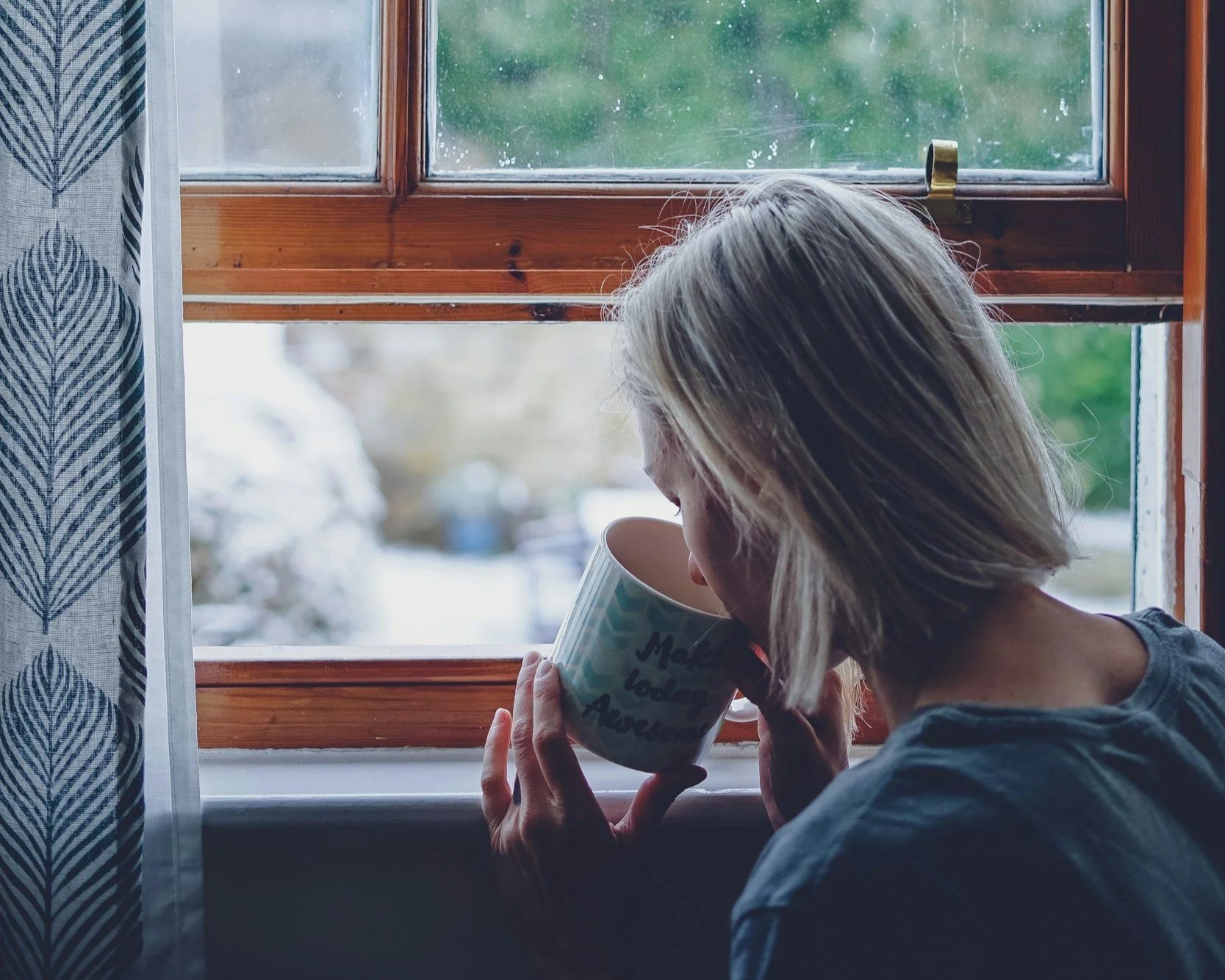 someone sitting with a cup of coffee