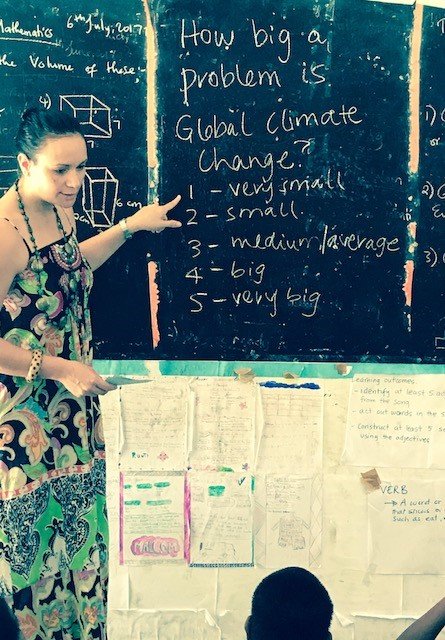 Teue setting up a class activity for year 5 students in Kiribati
