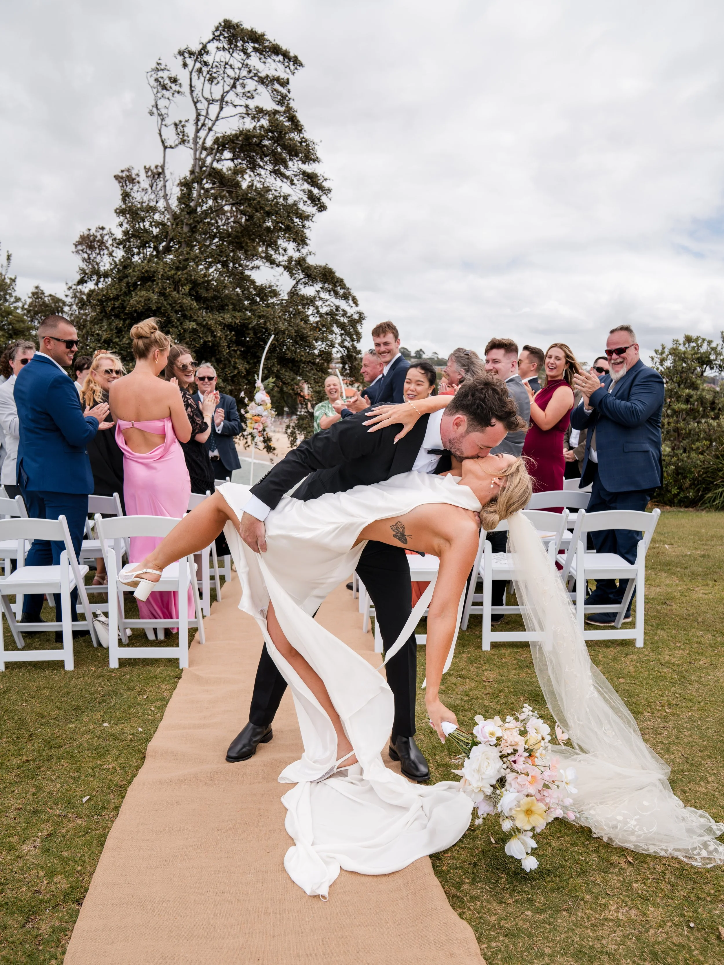 A dreamy Coogee Beach ceremony to a reception at the historic Victoria Barracks, Abbey and Joe’s day was the perfect blend of relaxed coastal vibes and timeless style. A white convertible Mustang added a touch of old-school cool to their portraits ef