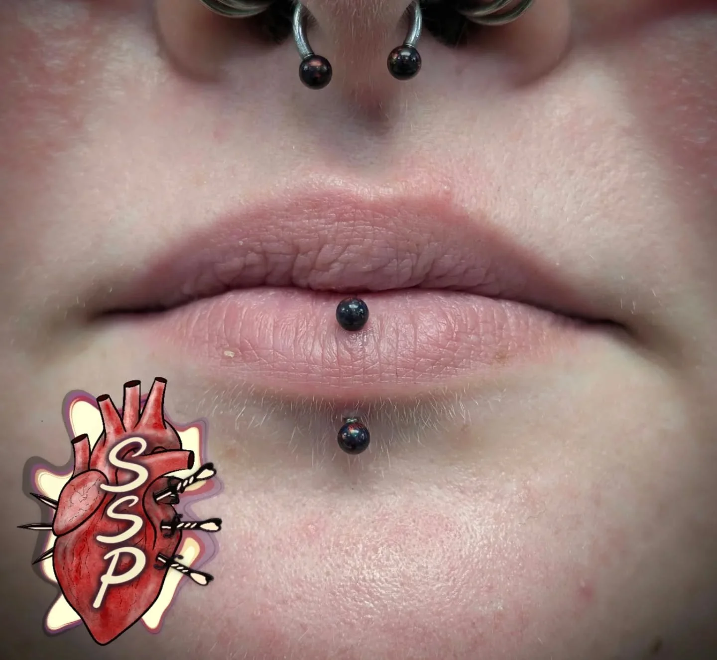 Black opal vertical labret with matching septum jewelry 

If you're interested in coming in for a piercing. There is no appointment needed, you can just come into the shop while we are open. Any questions about piercings you can always give the shop 