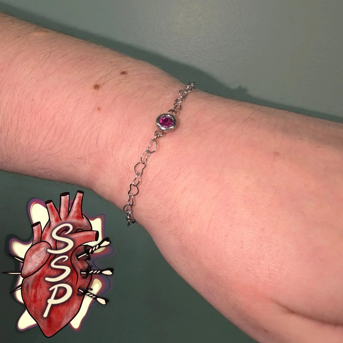 Forever heart bracelet with a pink charm to connect together. 

If you're interested in coming in for a piercing. There is no appointment needed, you can just come into the shop while we are open. Any questions about piercings you can always give the
