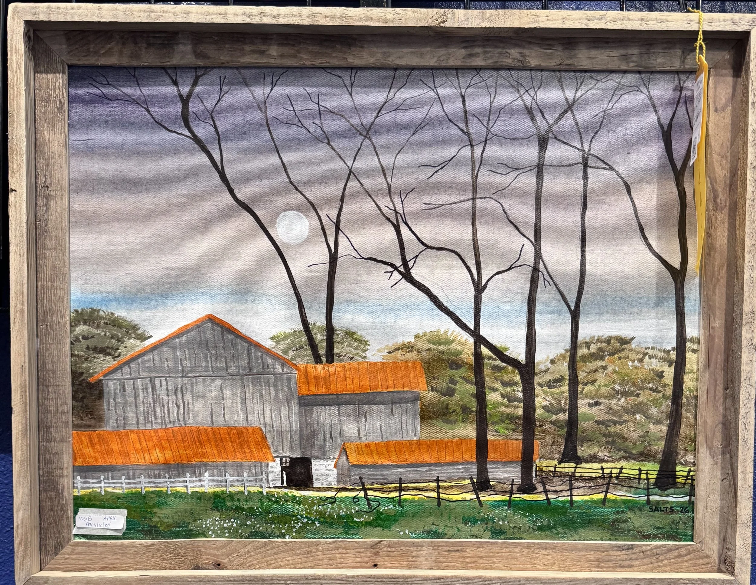 Painting of an outdoor farm scene featuring a barn with a red roof, a white fence, leafless trees, and a moon in the sky, framed in wood.