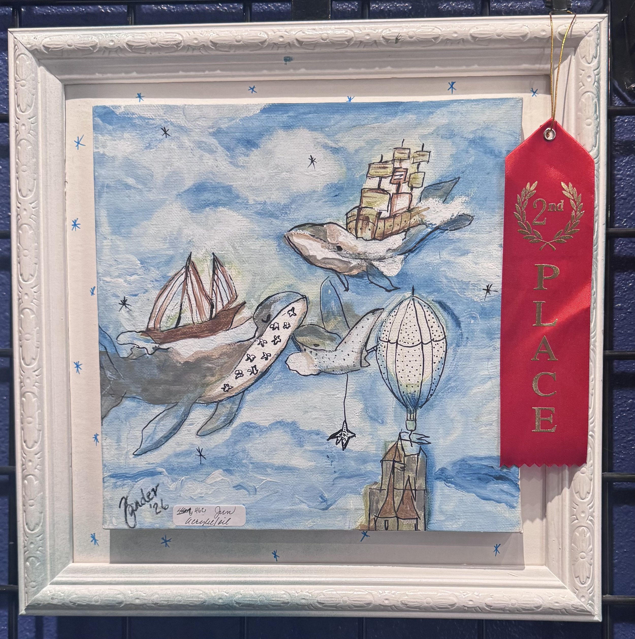 Watercolor painting of a ship with multiple masts on the sea, with clouds and blue sky in the background, inside a white decorative frame with a red ribbon hanging on the top right corner.