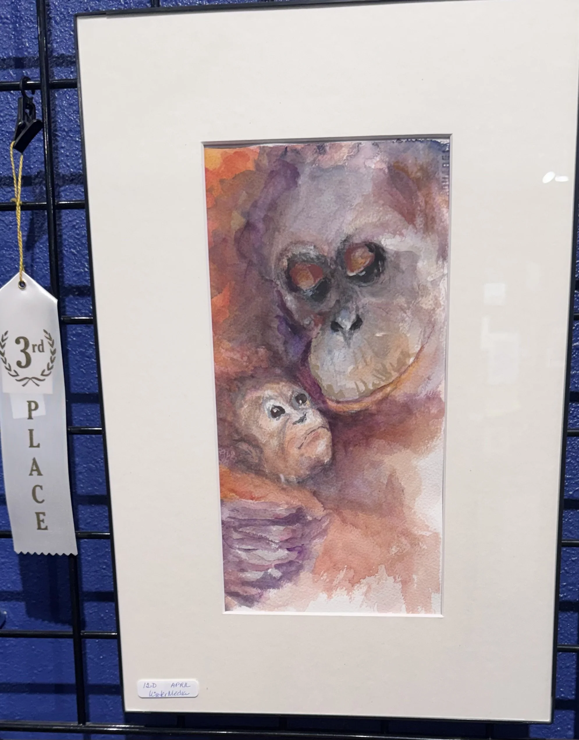 Watercolor painting of a person with glasses and an enigmatic expression, with a background of warm and cool tones. The artist's note indicates it was created on April 12th.