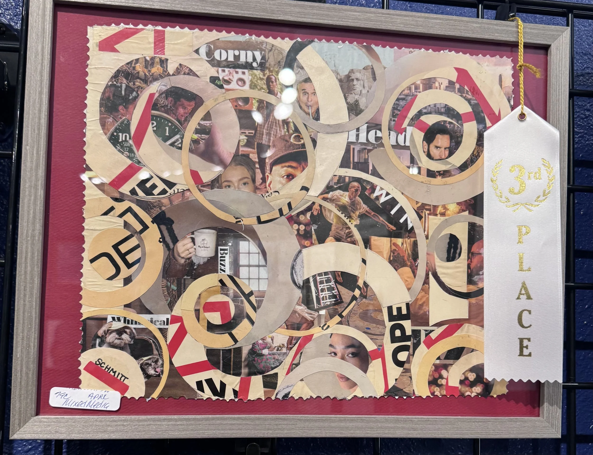 Collage of images and cutouts arranged in a spiral pattern, framed with a red background and a beige wooden border. Contains various photos of people, a dog, a clock, and text. A white card with gold lettering on the right reads '3rd' and 'PLACE'.