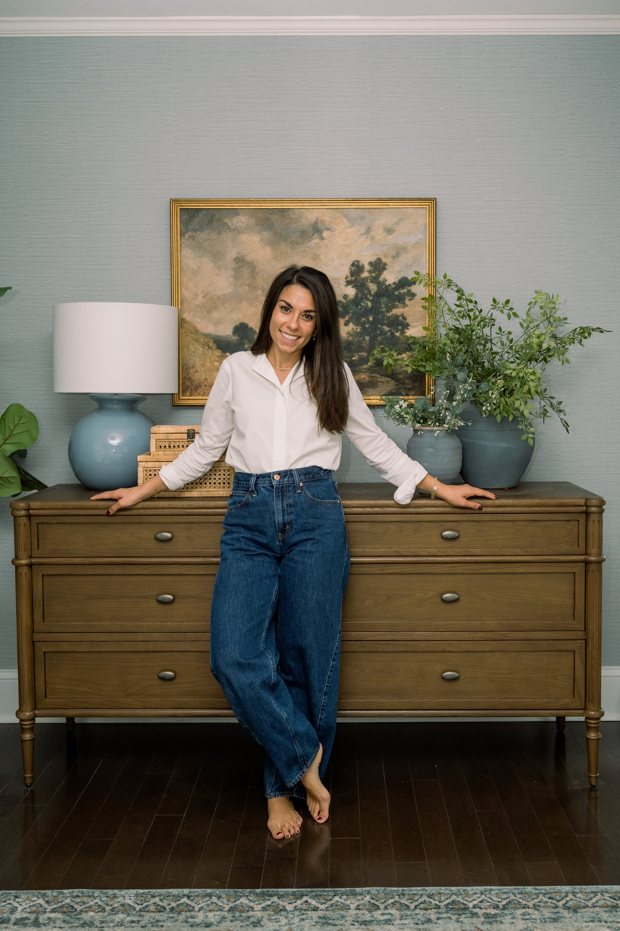 NJ based interior designer poses in primary bedroom suite