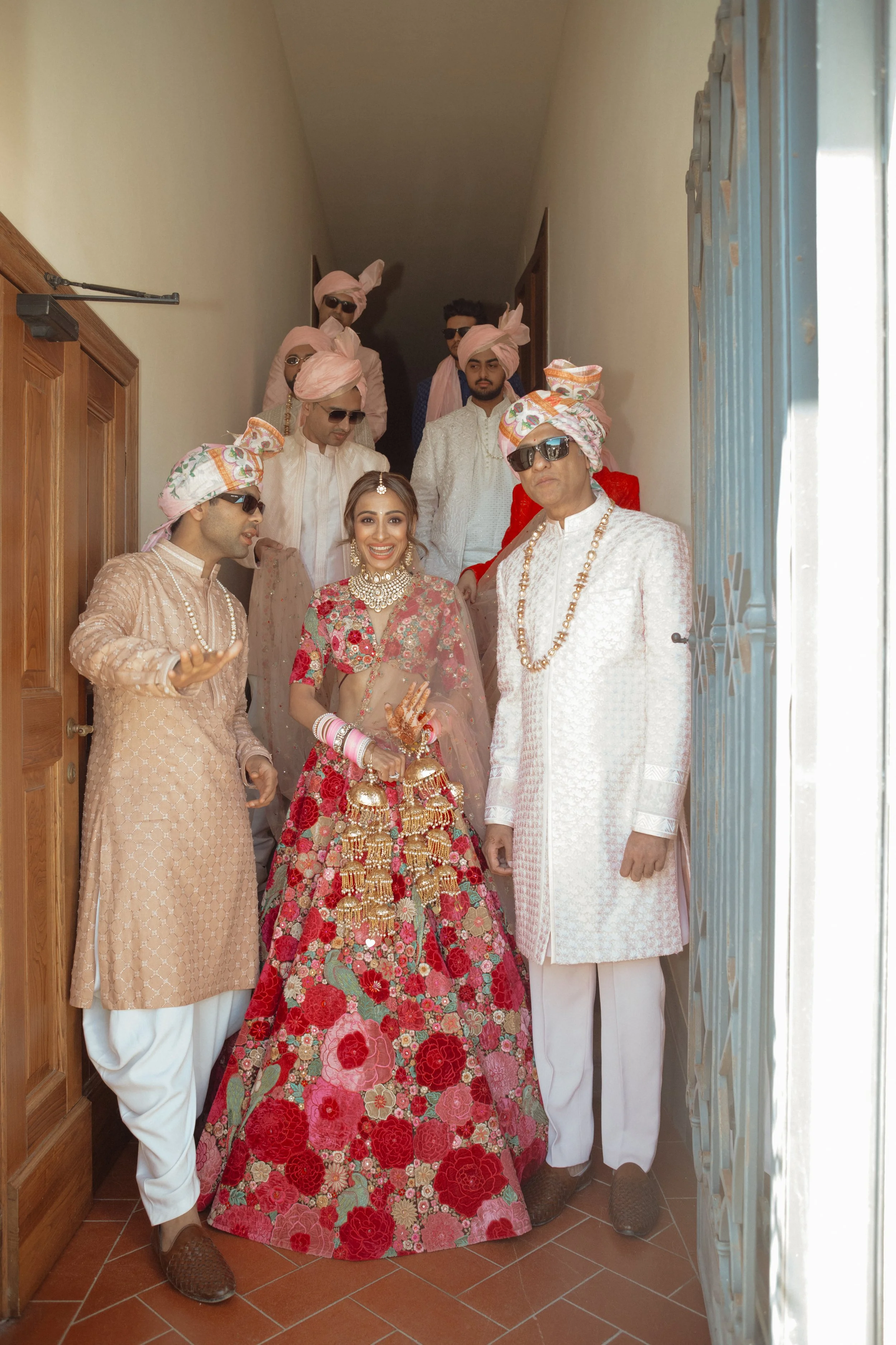 sahil-aashna-luxury-indian-wedding-il-borro-tuscany-bride-walking-with-family.jpg