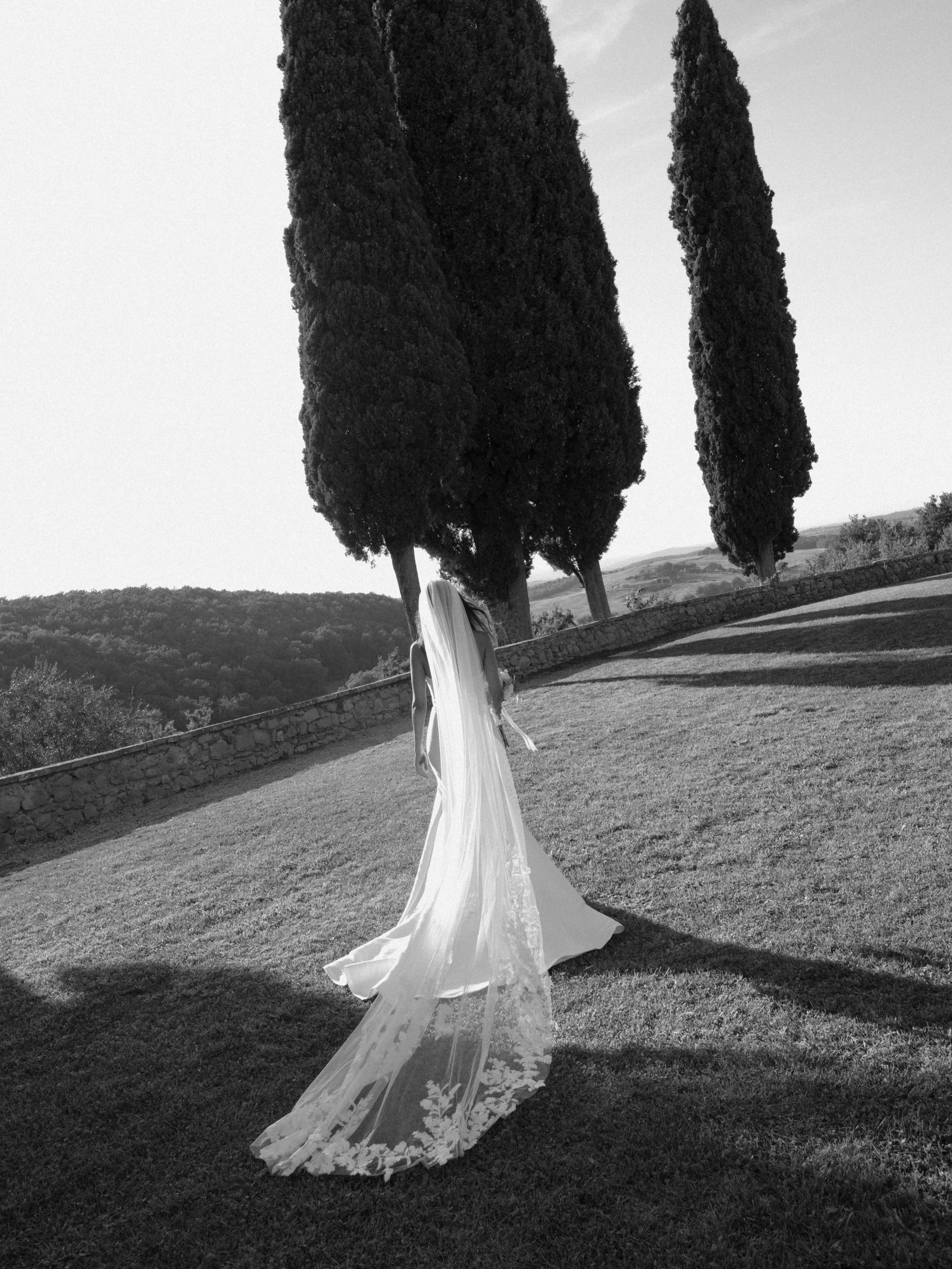 We&rsquo;ve already shared Sara in her stunning Sudanese bridal dress. 
But before that, there was this.
Her Western bridal look, beneath the Tuscan cypresses.
A different chapter of the same day. A different expression of who she is.
Sara and Thibau