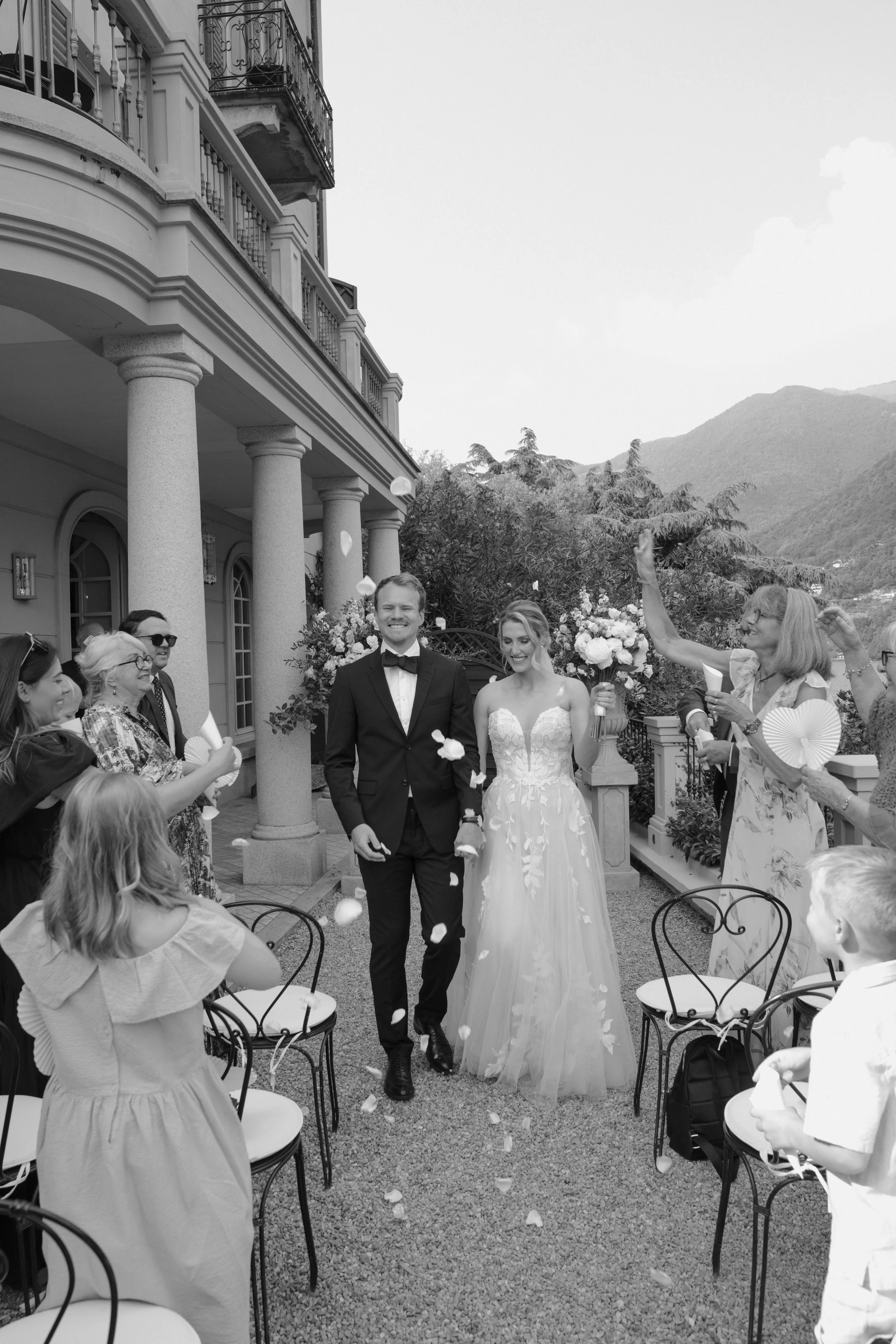 Bride and groom walking through guests after an intimate wedding ceremony at a Lake Como Relais Villa Vittoria