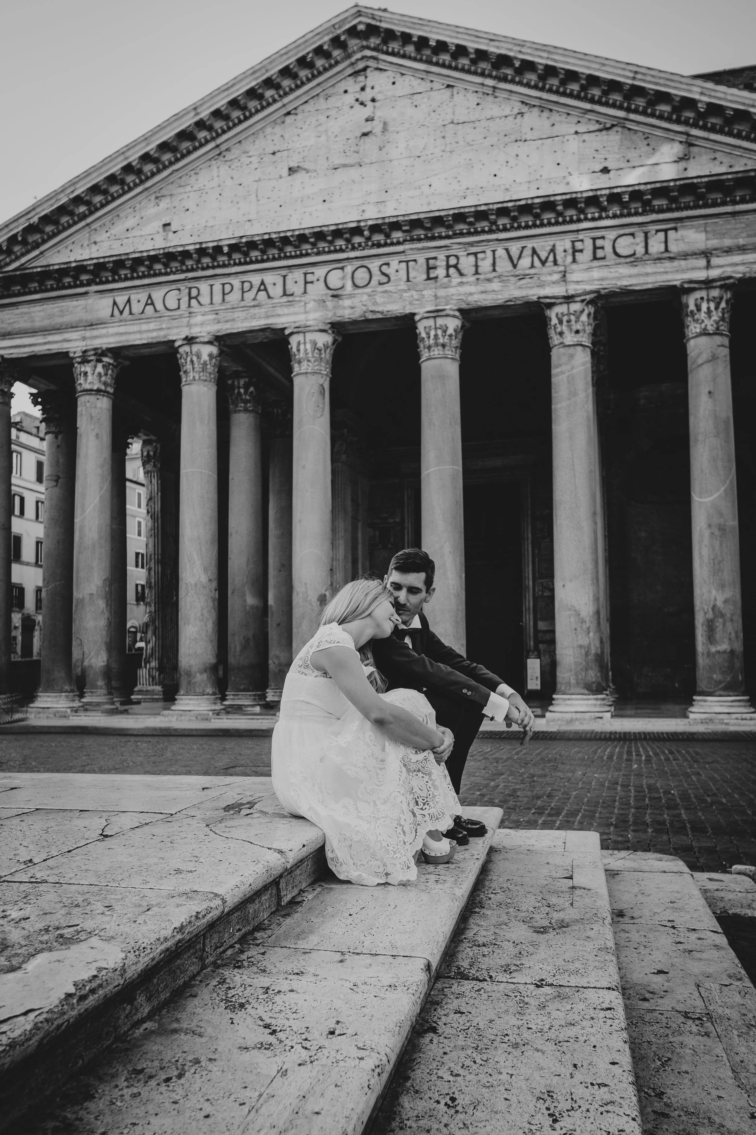 Bride and groom seated together in front of the Pantheon during a Rome elopement