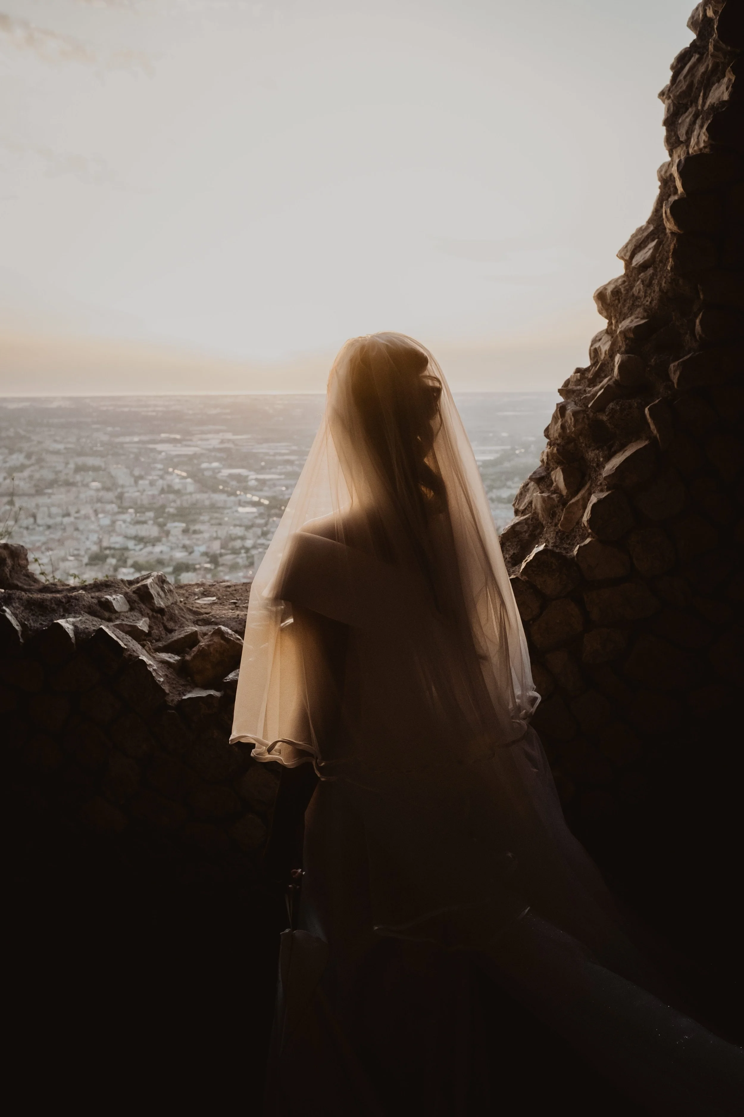 Romantic bridal portrait overlooking an Italian city at sunset, combining emotion, light, and cinematic destination wedding atmosphere.