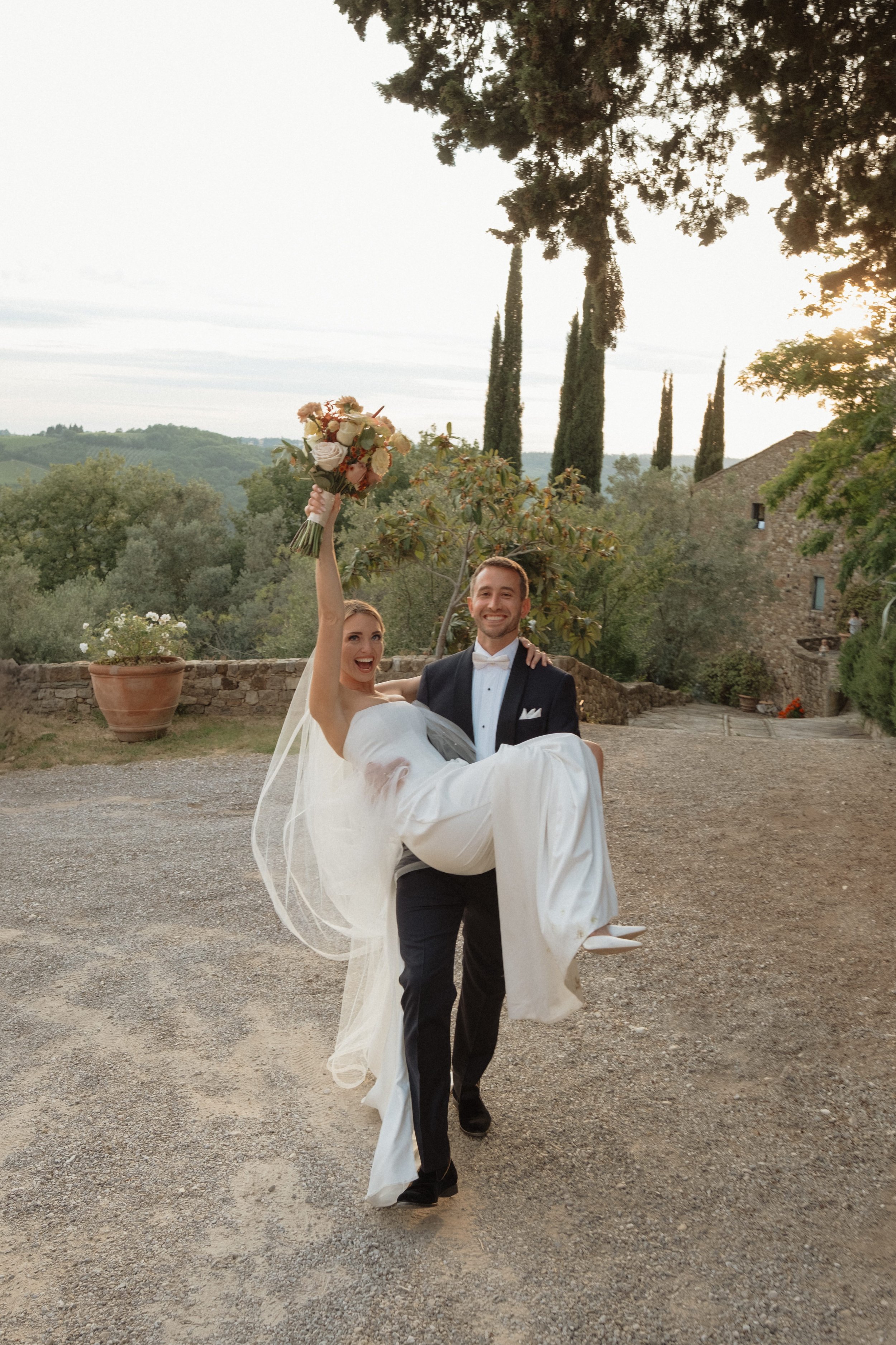 Happy Bride Being Lifted by Groom in Countryside Wedding | Elegant Wedding Photography in Tuscany