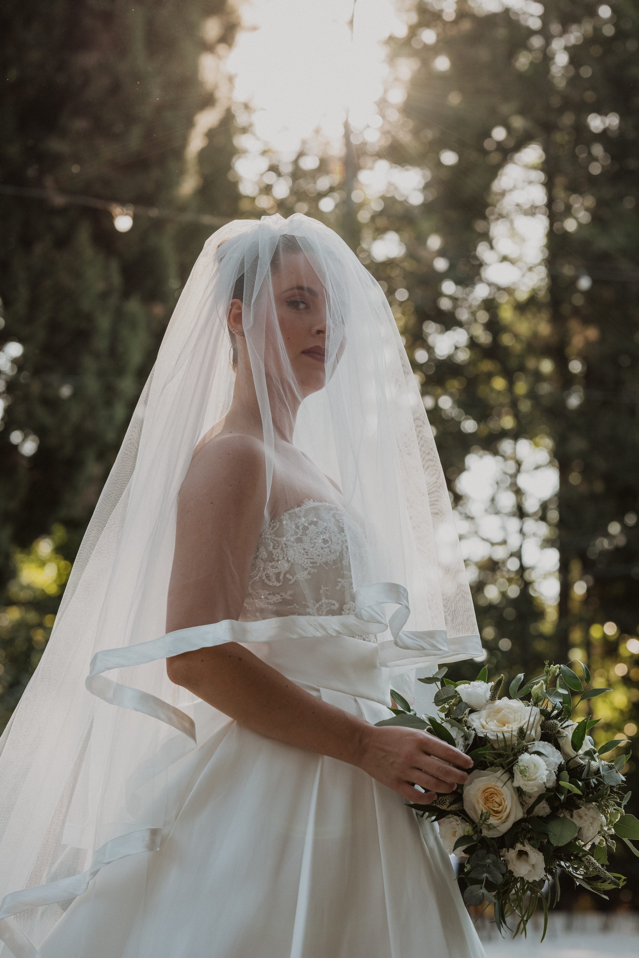 Bridal Portrait with Veil in Sunlight | Luxury Wedding Photography in Tuscany