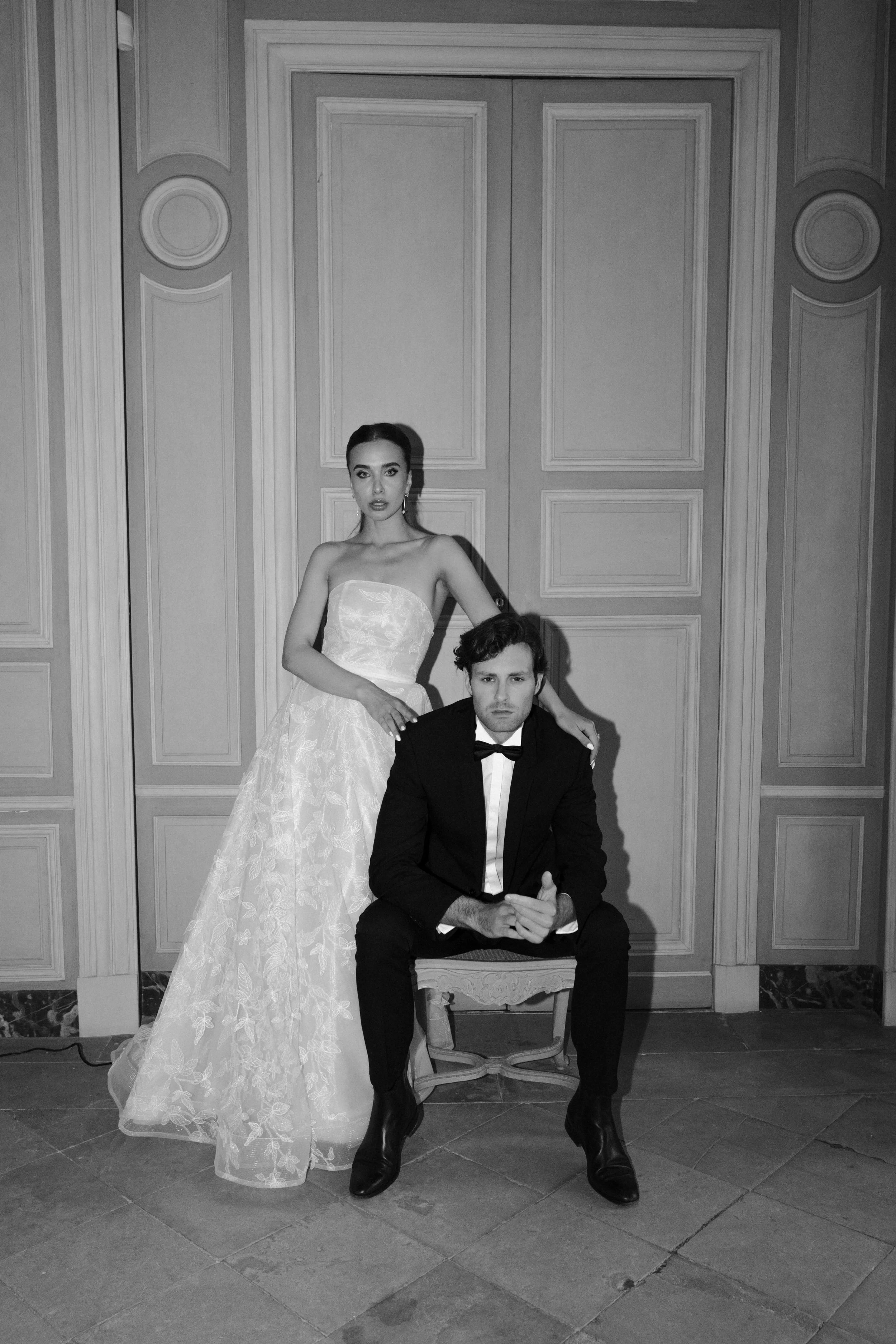 A sophisticated bridal couple portrait at Château Villette, photographed in a cinematic black-and-white style with strong fashion and editorial influence.