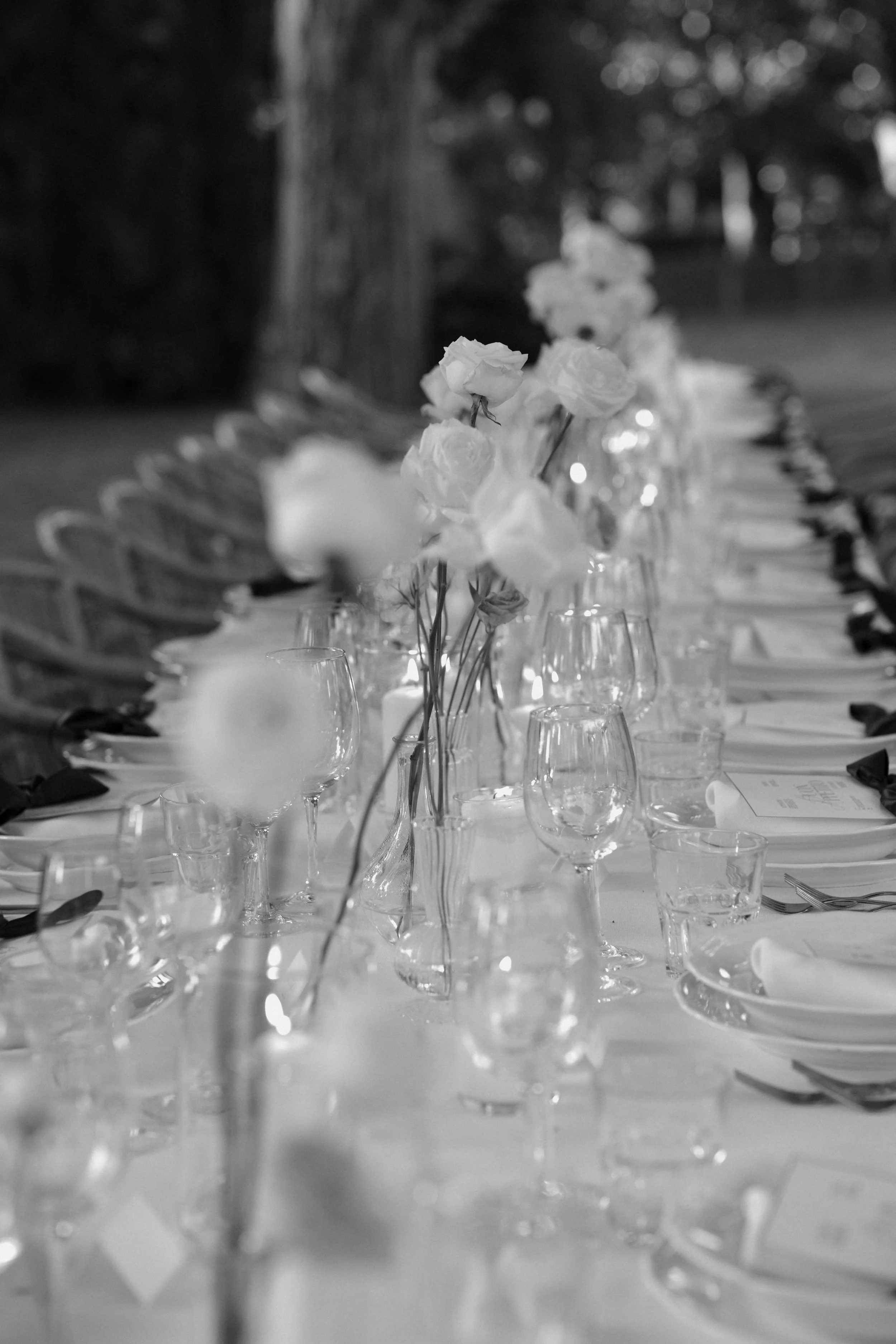 An elegant outdoor wedding dinner in Italy, defined by refined table styling, candlelight, and timeless floral design for a truly bespoke luxury celebration