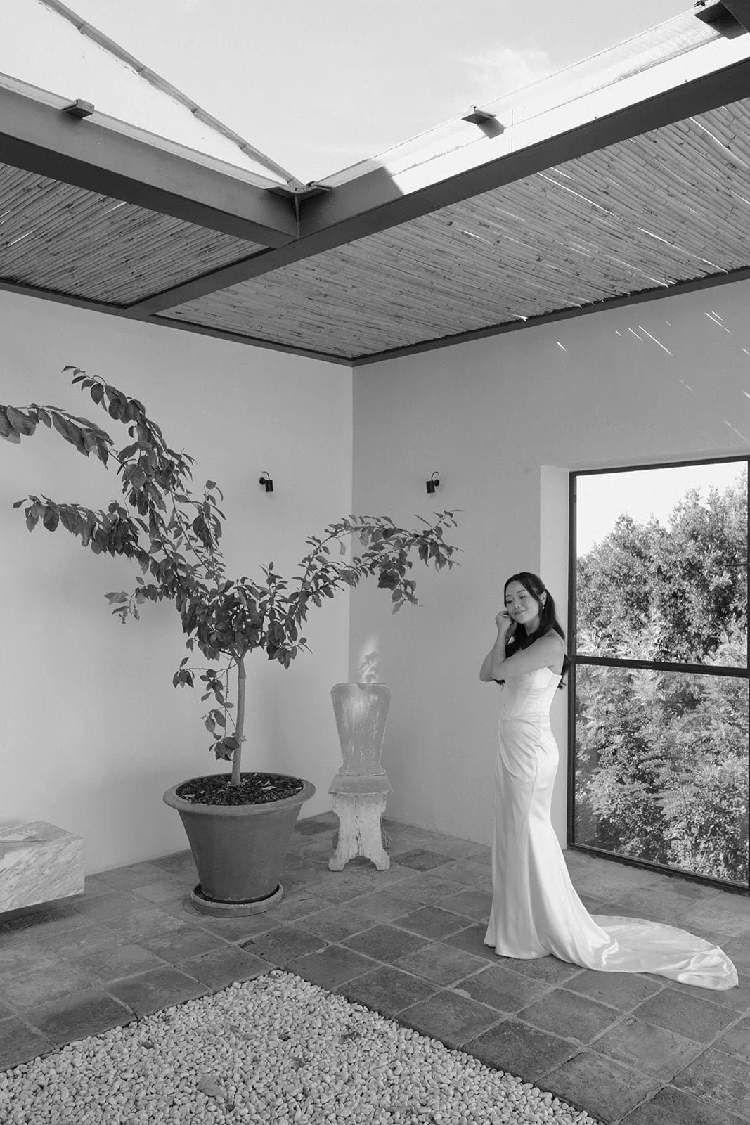 A contemplative bridal portrait captured in black and white, highlighting form, light, and modern Tuscan design.