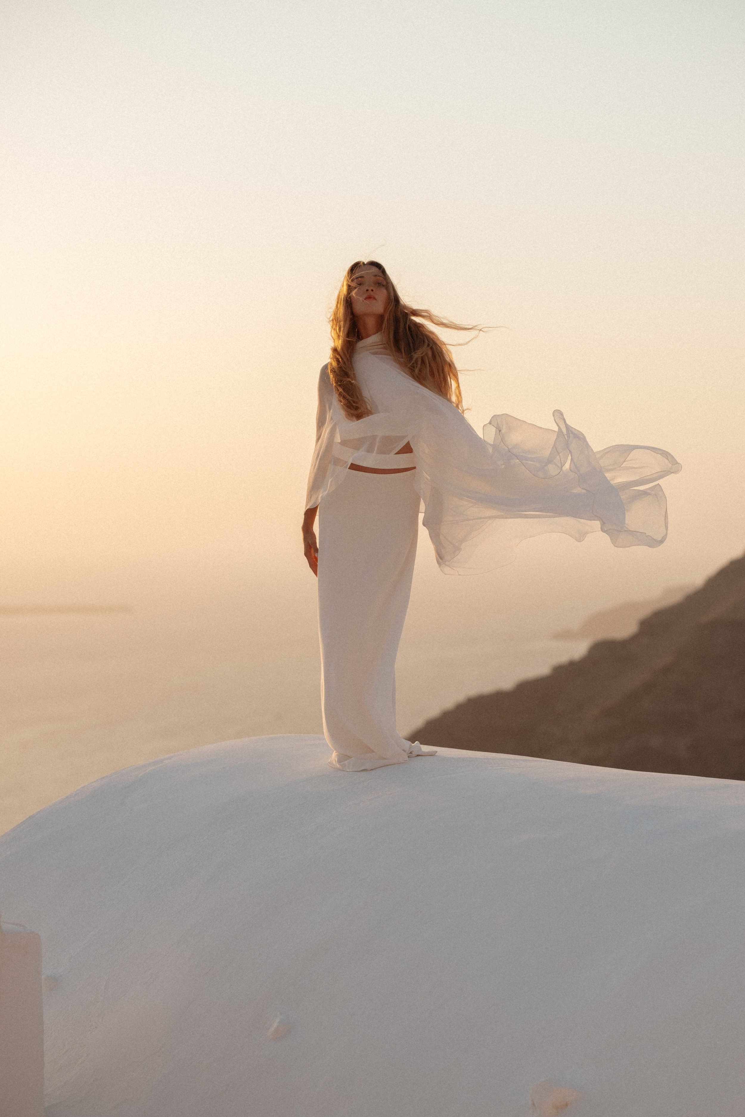 Sunset Bride on Santorini Clifftop | Dreamy Destination Elopement