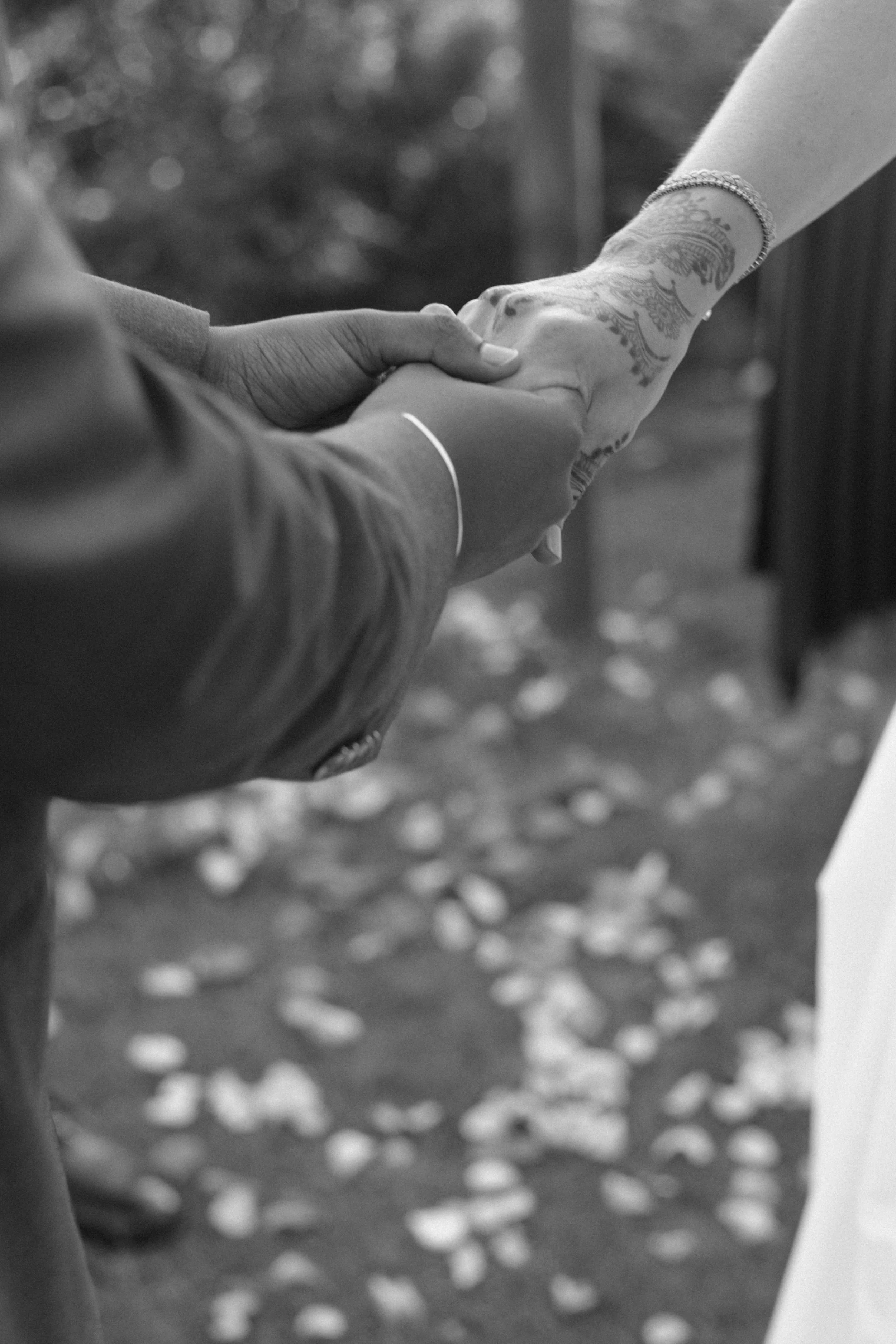 Close-up of hands joined during an Indian wedding ritual in Tuscany, symbolizing connection, tradition, and intimacy.