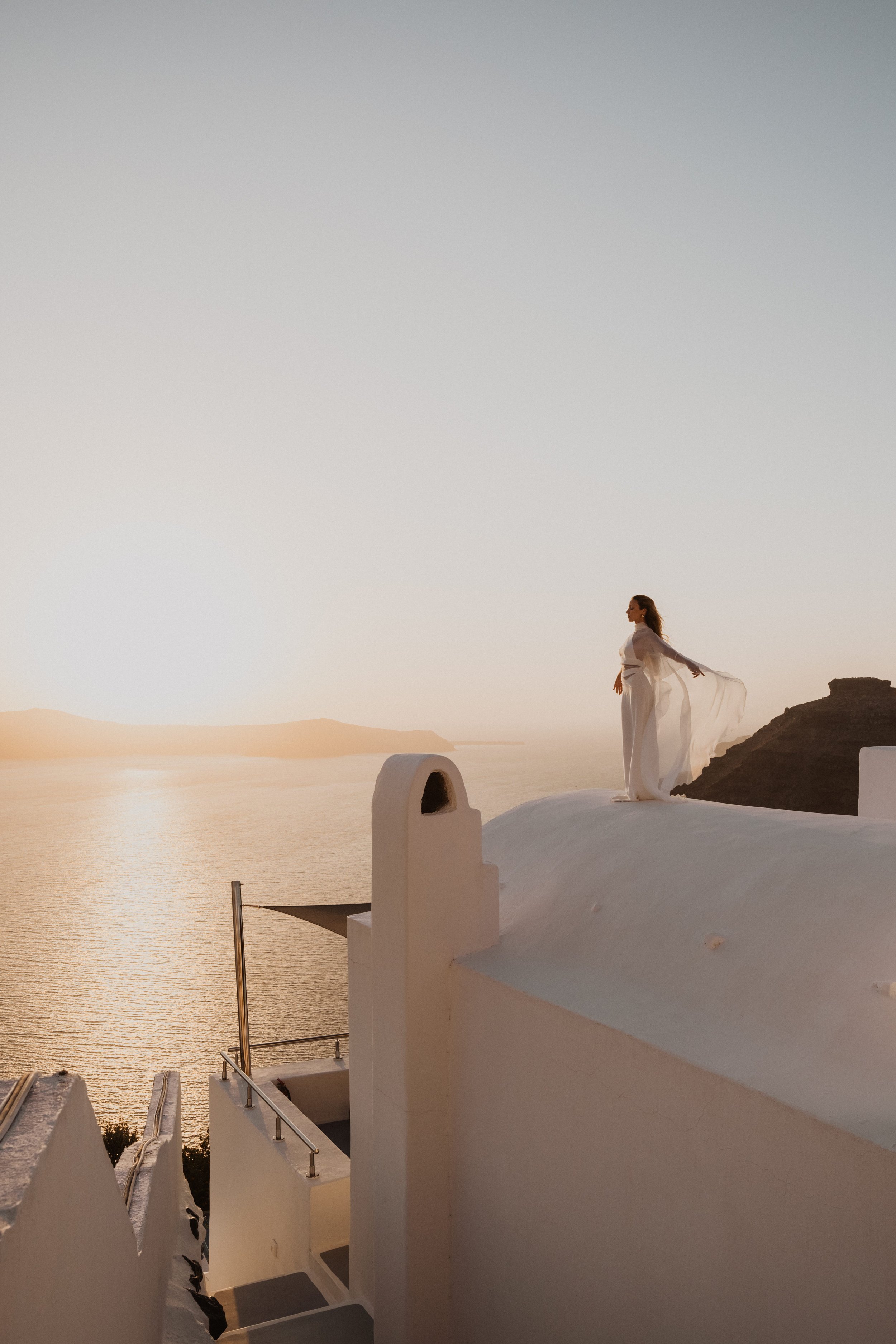 Sunset Wedding Shoot in Santorini | Bride in White Dress on Rooftop with Sea View