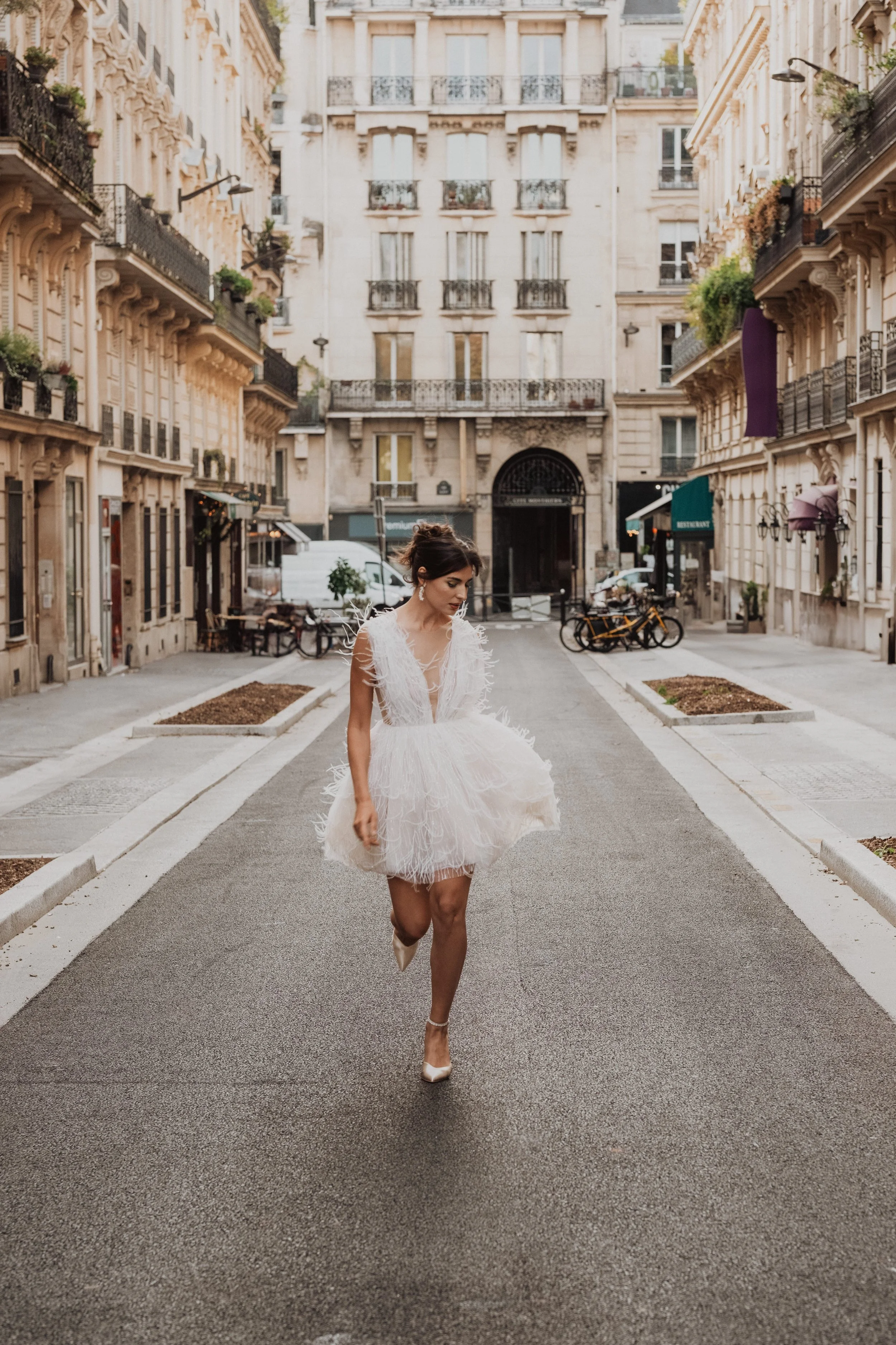 An editorial bridal portrait in the streets of Paris, blending modern couture, movement, and timeless European elegance.