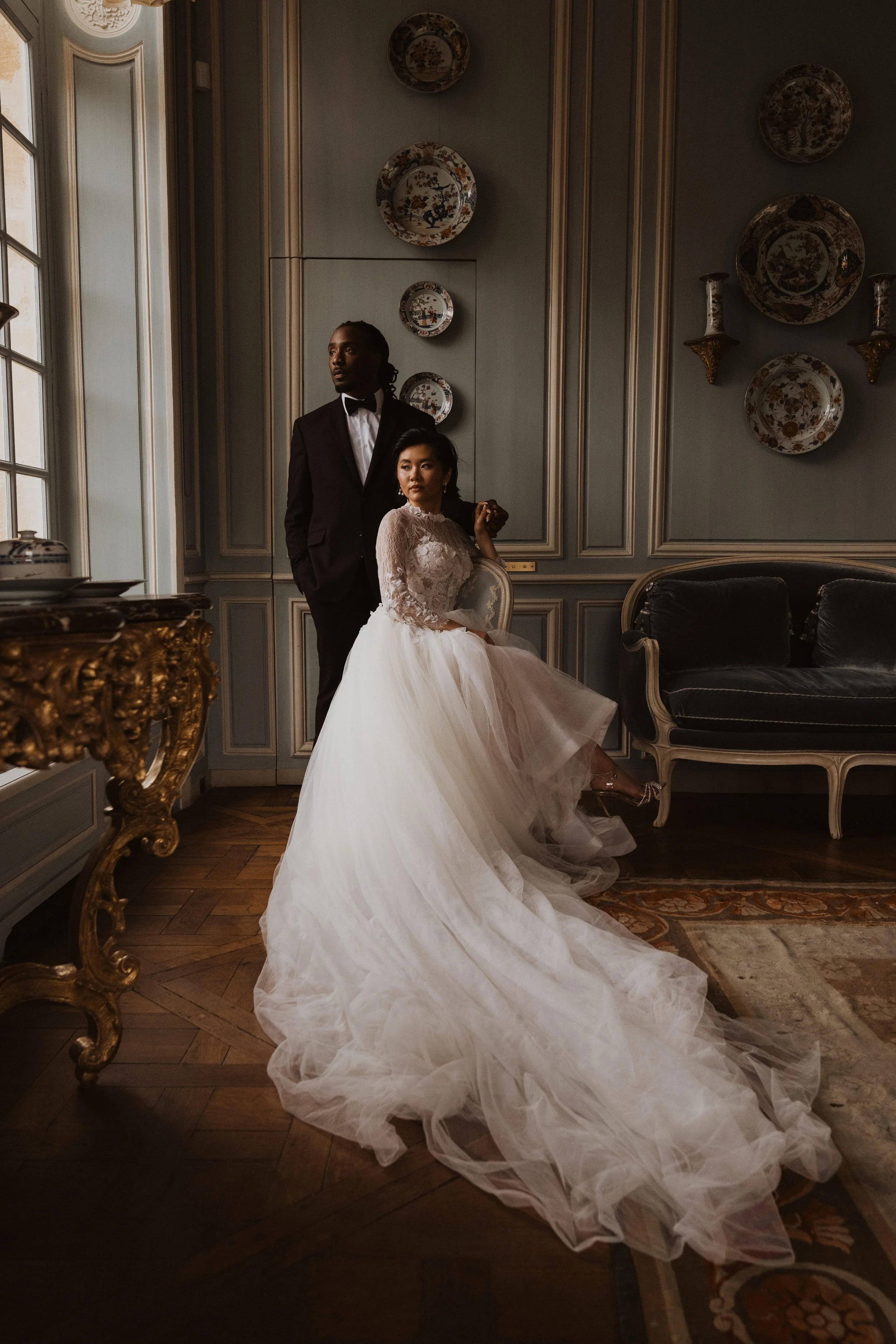 A refined wedding portrait captured in Paris, highlighting architectural elegance and a contemporary destination wedding aesthetic at Château de Villette.