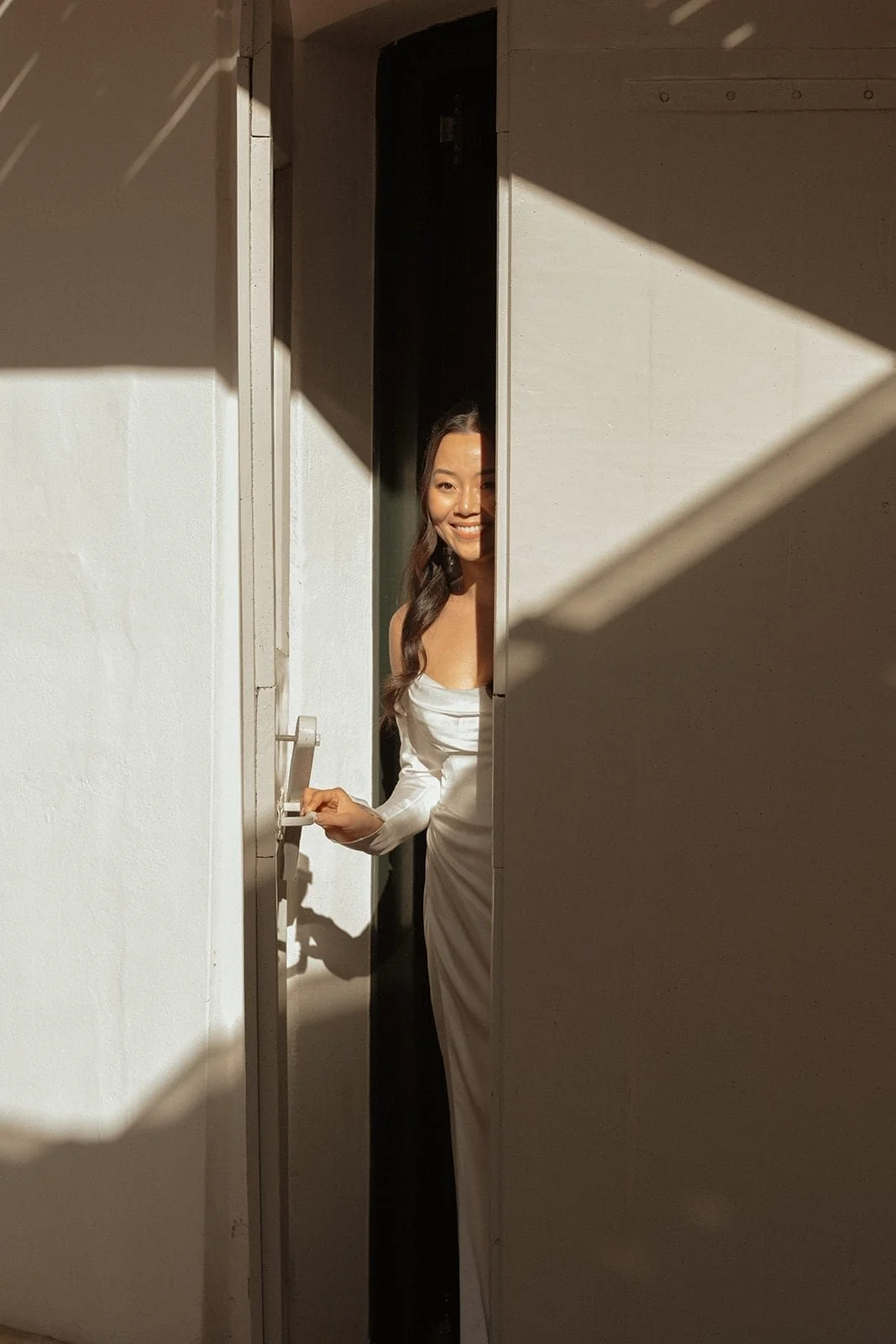 A close portrait of the bride smiling during the vows, captured inside a modern Tuscan villa with gentle light and an intimate mood.