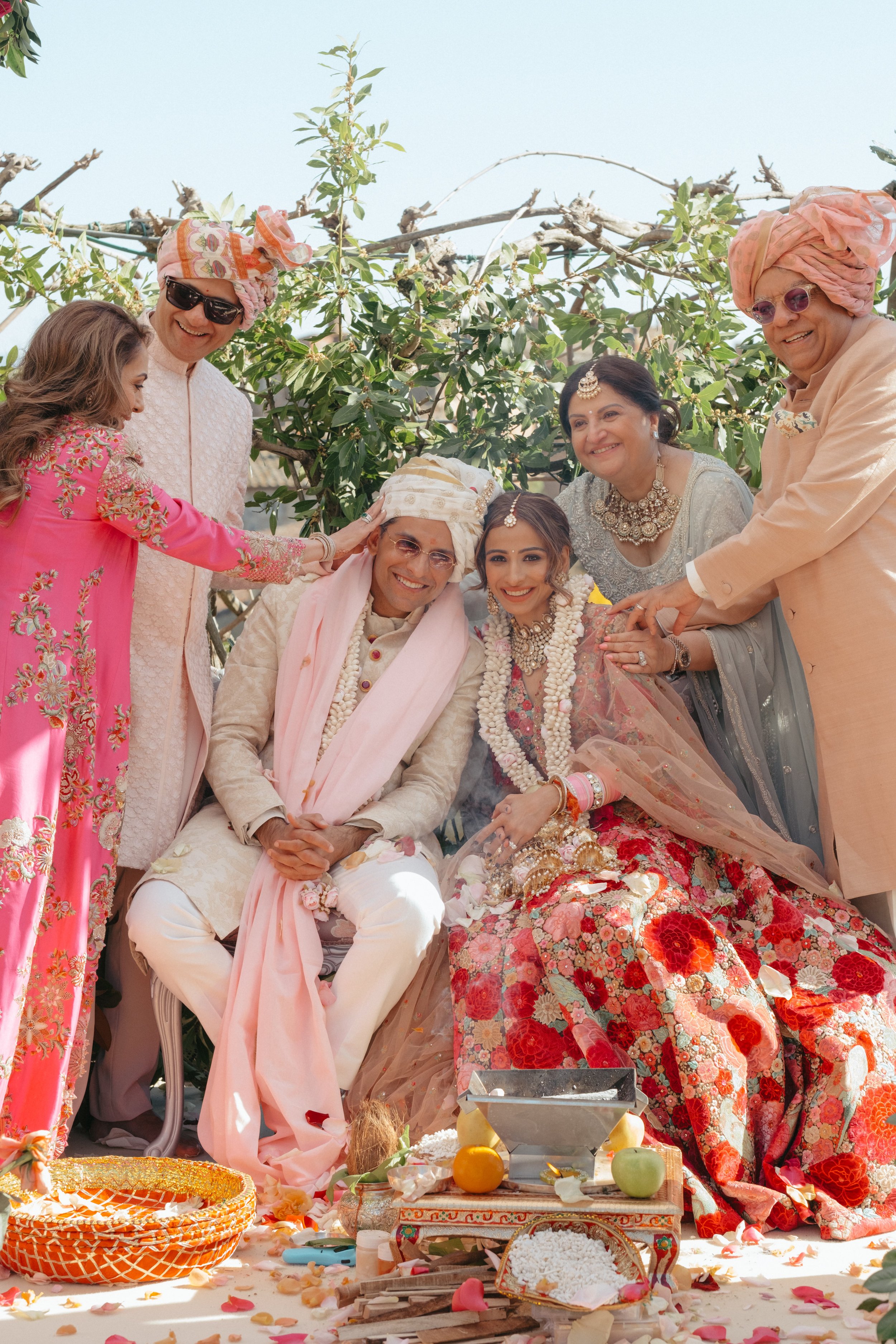 A couple receiving blessings from family during an Indian heritage wedding ceremony at Il Borro in Tuscany