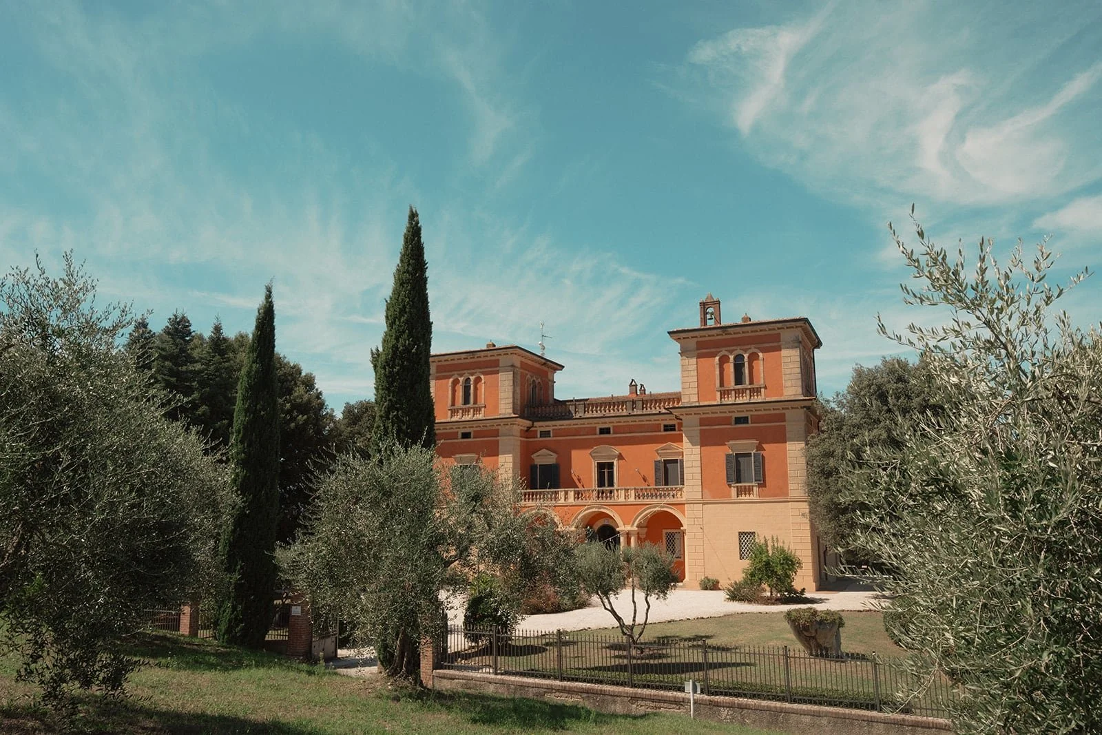 Wide view of Villa Lena surrounded by olive trees and rolling hills, a perfect backdrop for an intimate destination wedding.