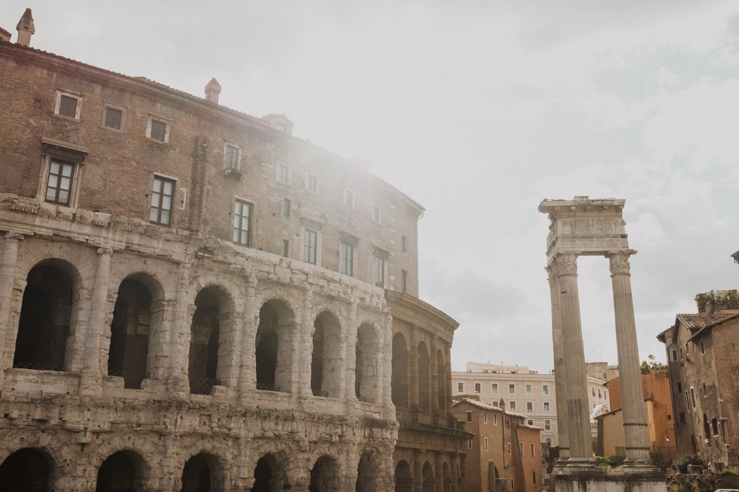 Soft evening light over the Theatre of Marcellus and ancient Roman columns, capturing the timeless architecture and layered history of Rome in a refined, editorial style.