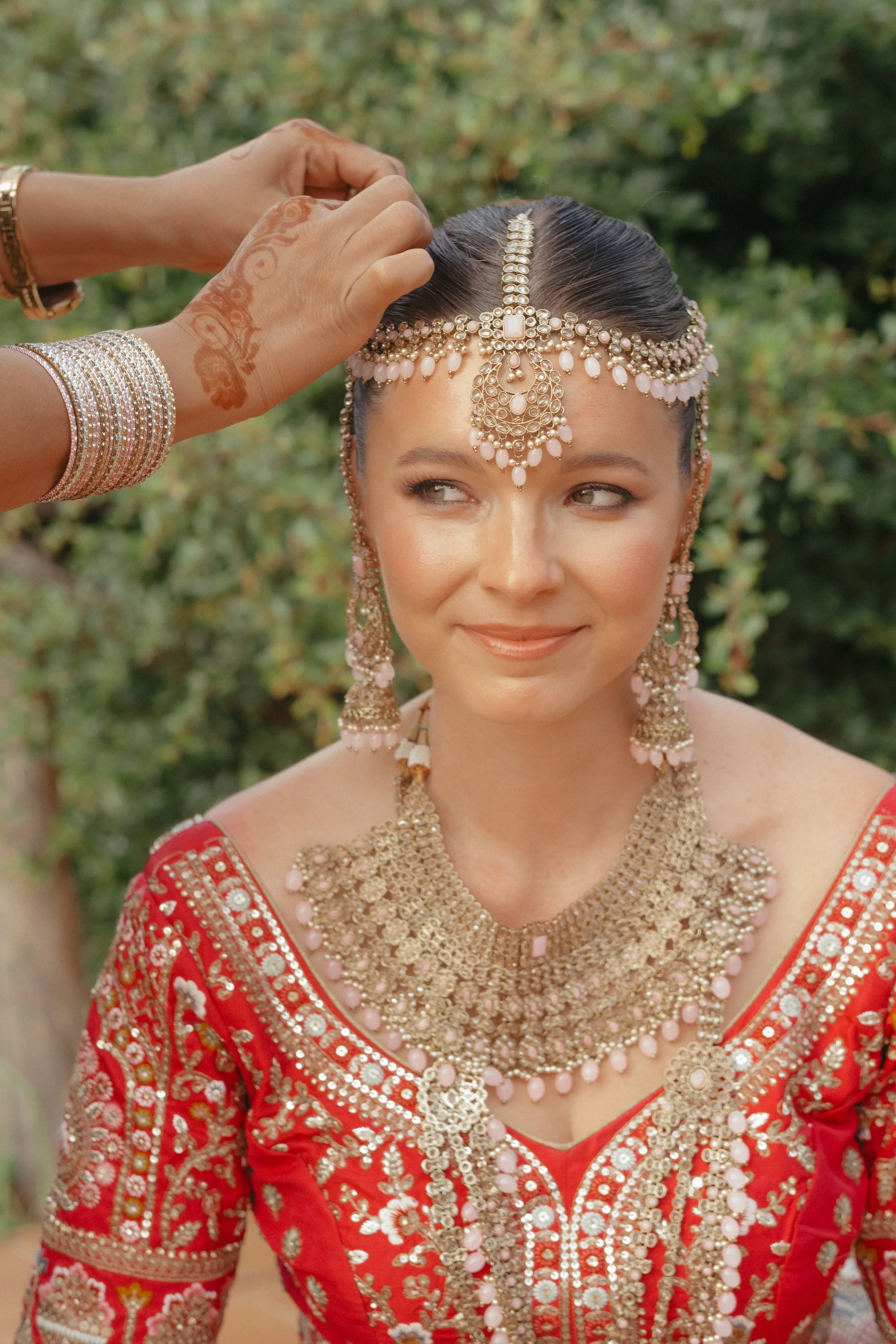 Indian bride wearing traditional bridal jewellery during a destination wedding ceremony in Tuscany, captured in an elegant and timeless editorial style.