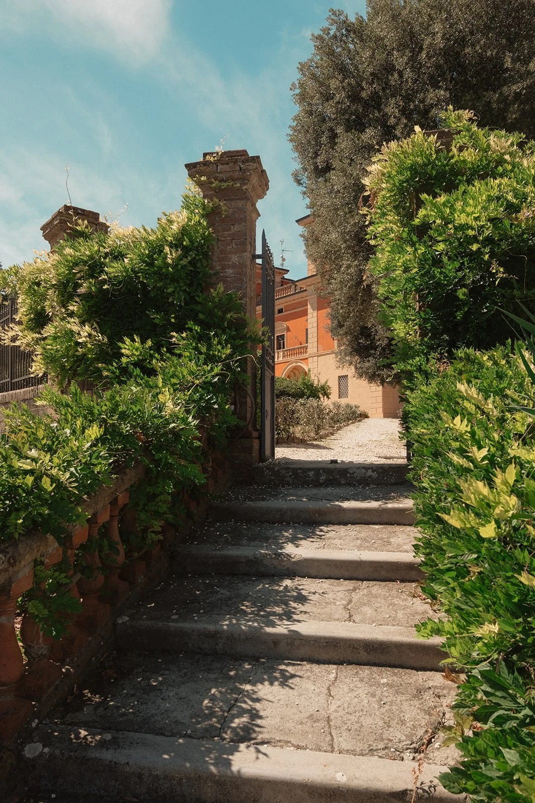 Stone steps and greenery leading to Villa Lena, setting the tone for a relaxed and elegant destination wedding.