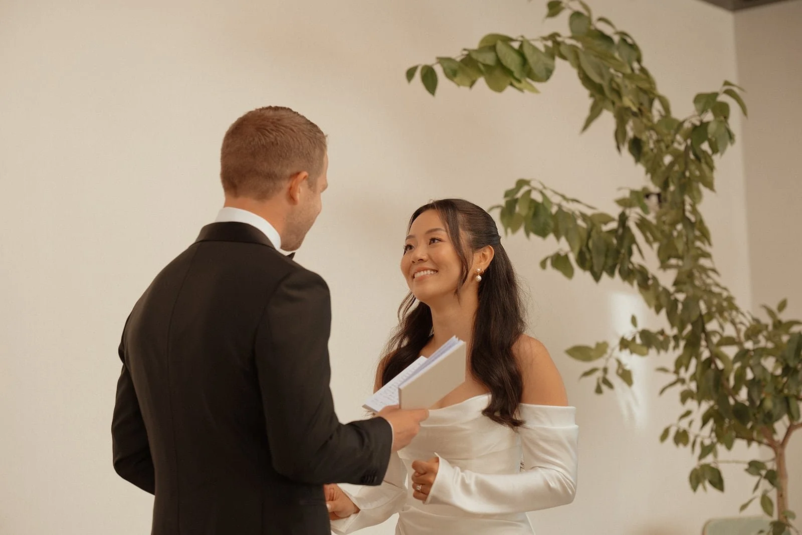A romantic first look moment between the bride and groom inside a contemporary Tuscan villa, captured with natural light and understated elegance.