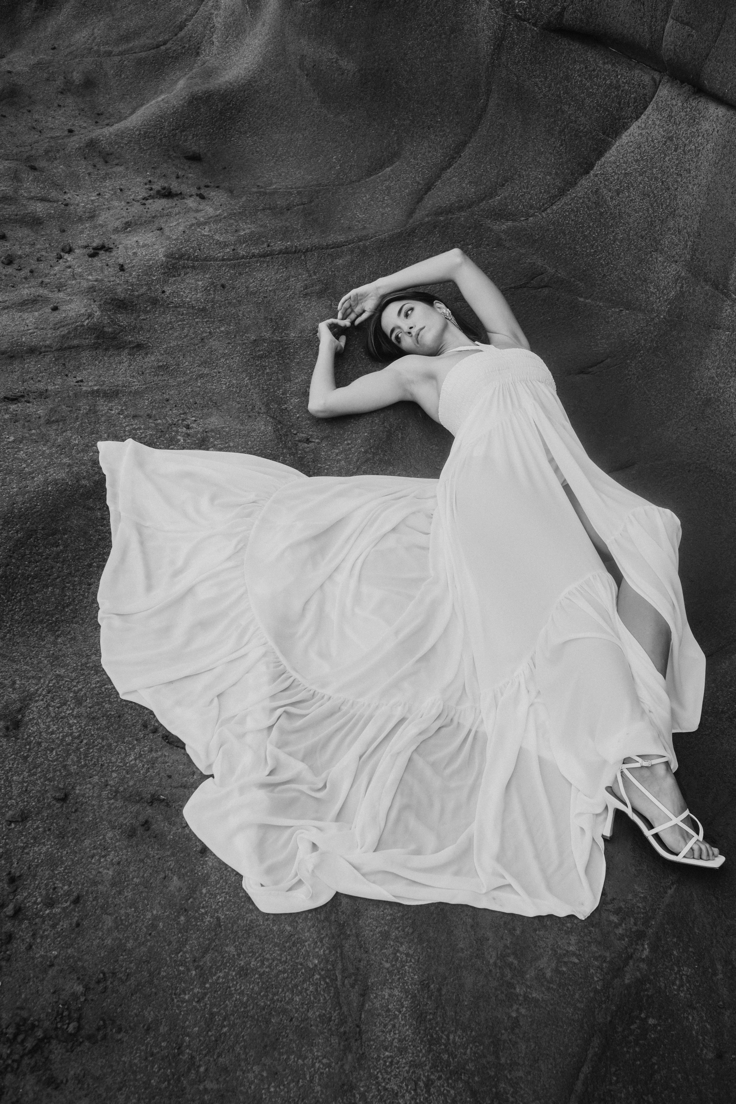 Luxury bridal editorial featuring a modern bride styled against natural stone textures, blending fashion, elegance, and contemporary wedding inspiration.
