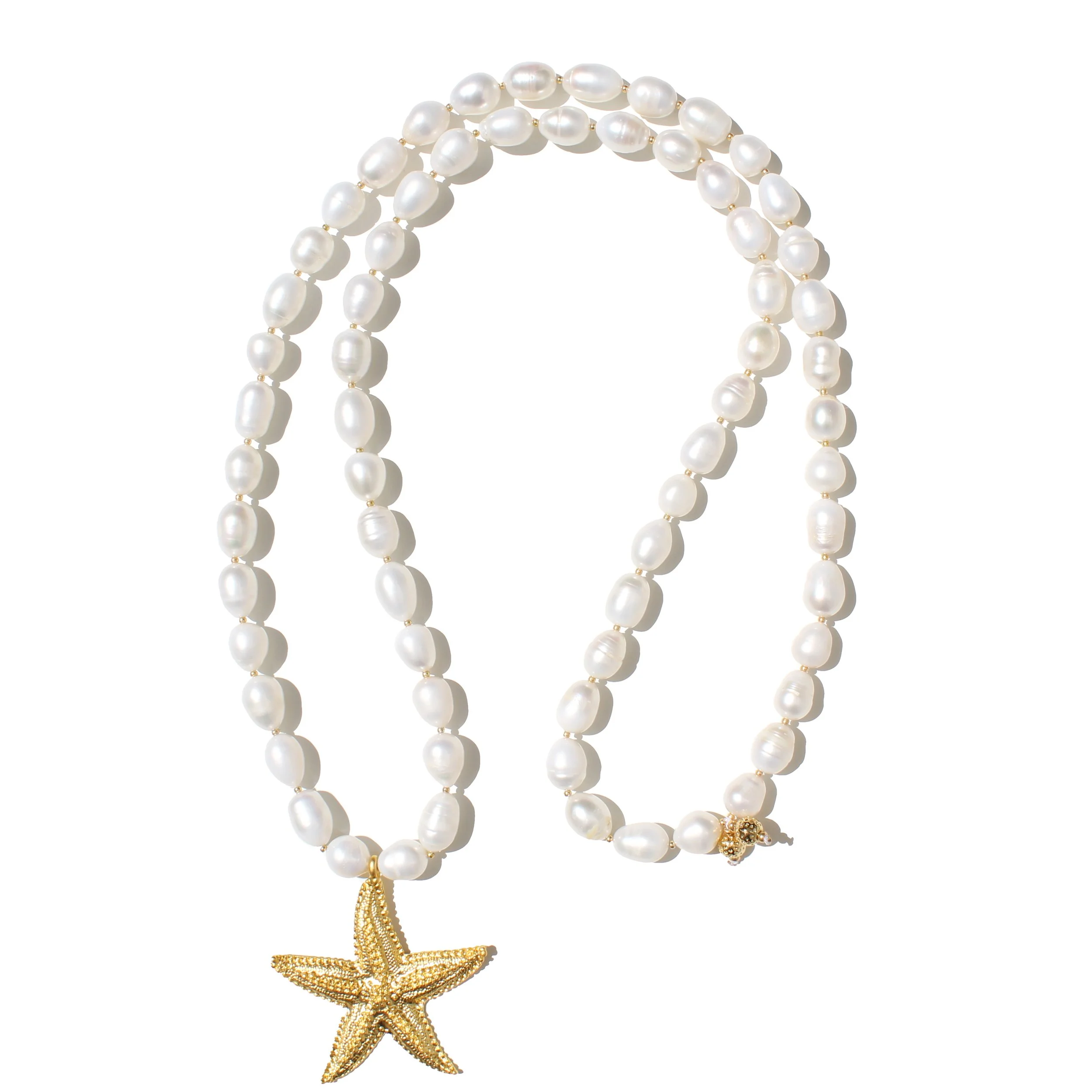 A pearl necklace with a gold starfish pendant against a white background.
