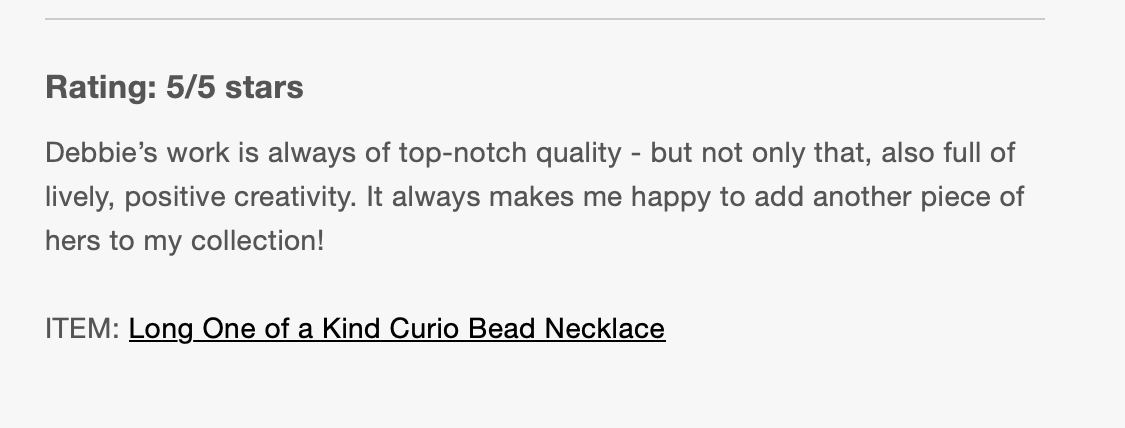Screenshot of a review for a necklace, rated 5 out of 5 stars, describing the work as top-notch and creatively made, featuring a long curiosity bead necklace.