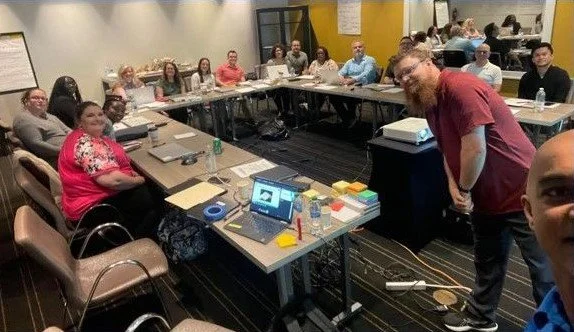 Leading a corporate FP&A training workshop with participants seated in a U-shape