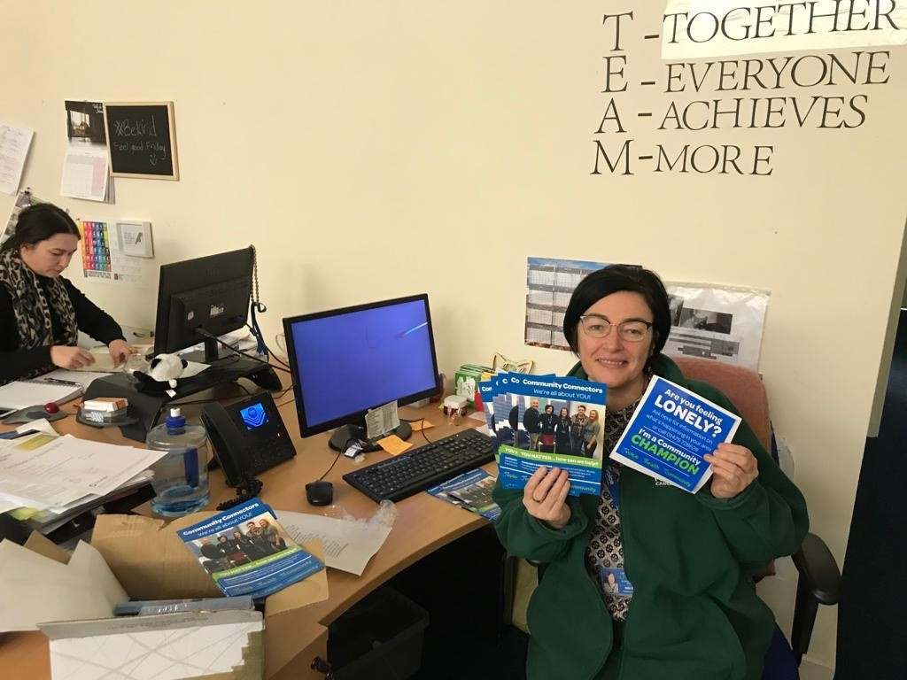 Community Connector holding leaflets