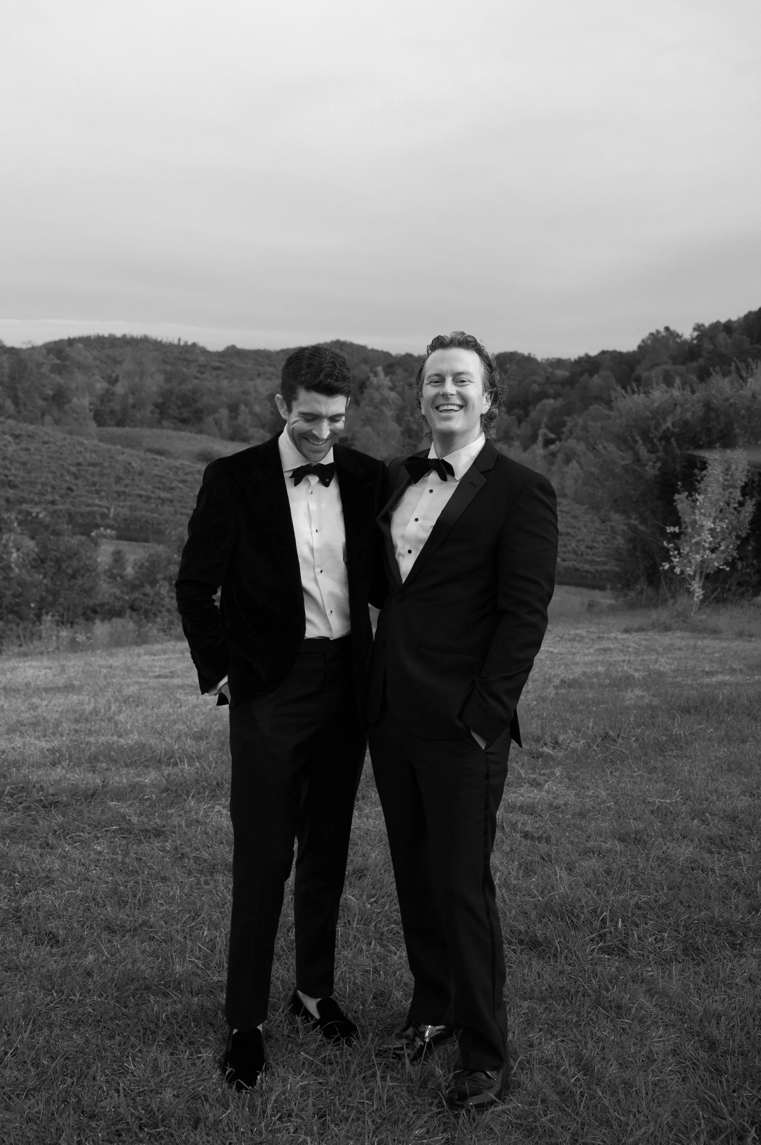 Artistic candid portrait of two grooms sharing a quiet moment
