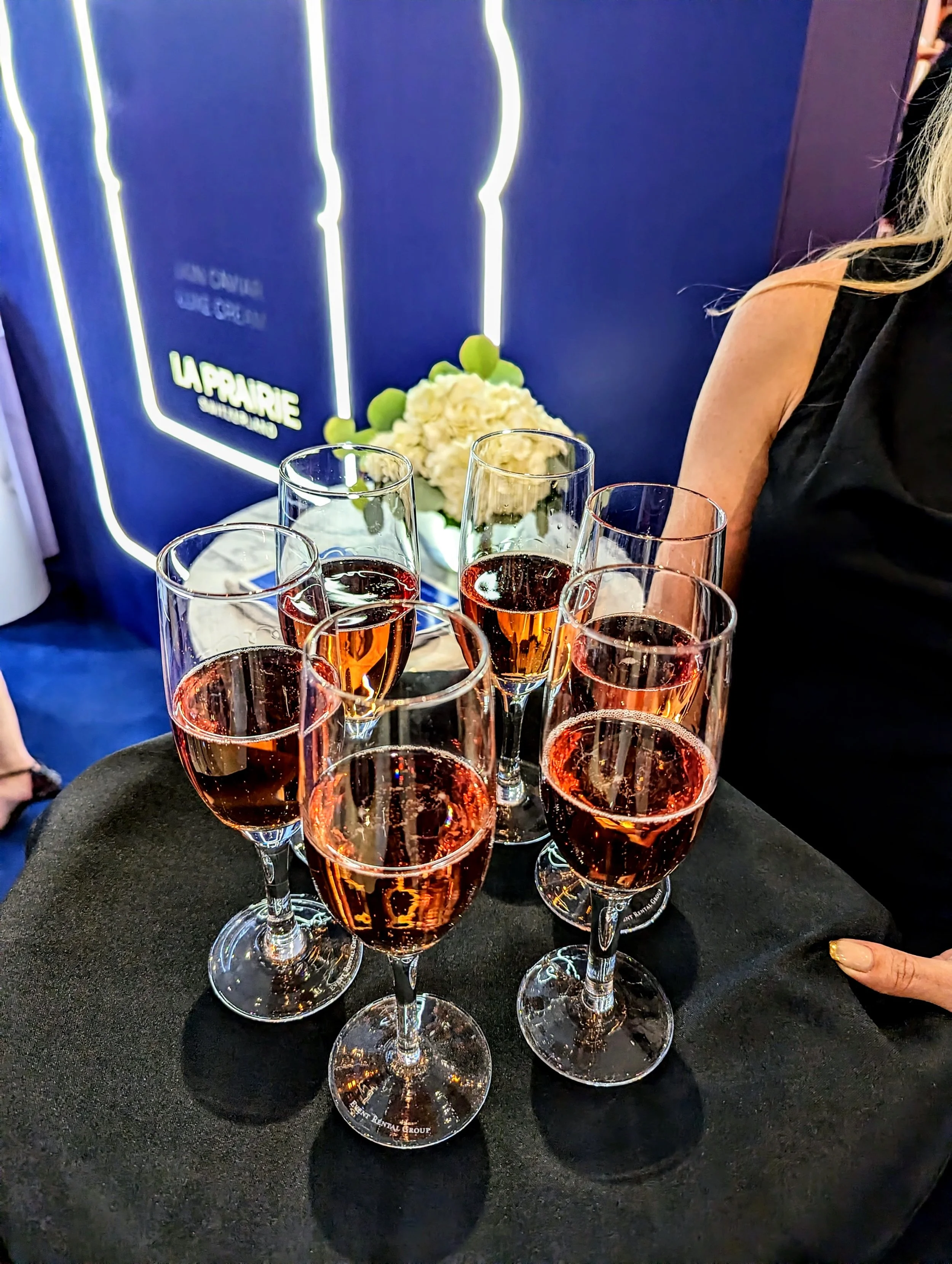 Server holding tray with glasses of champagne