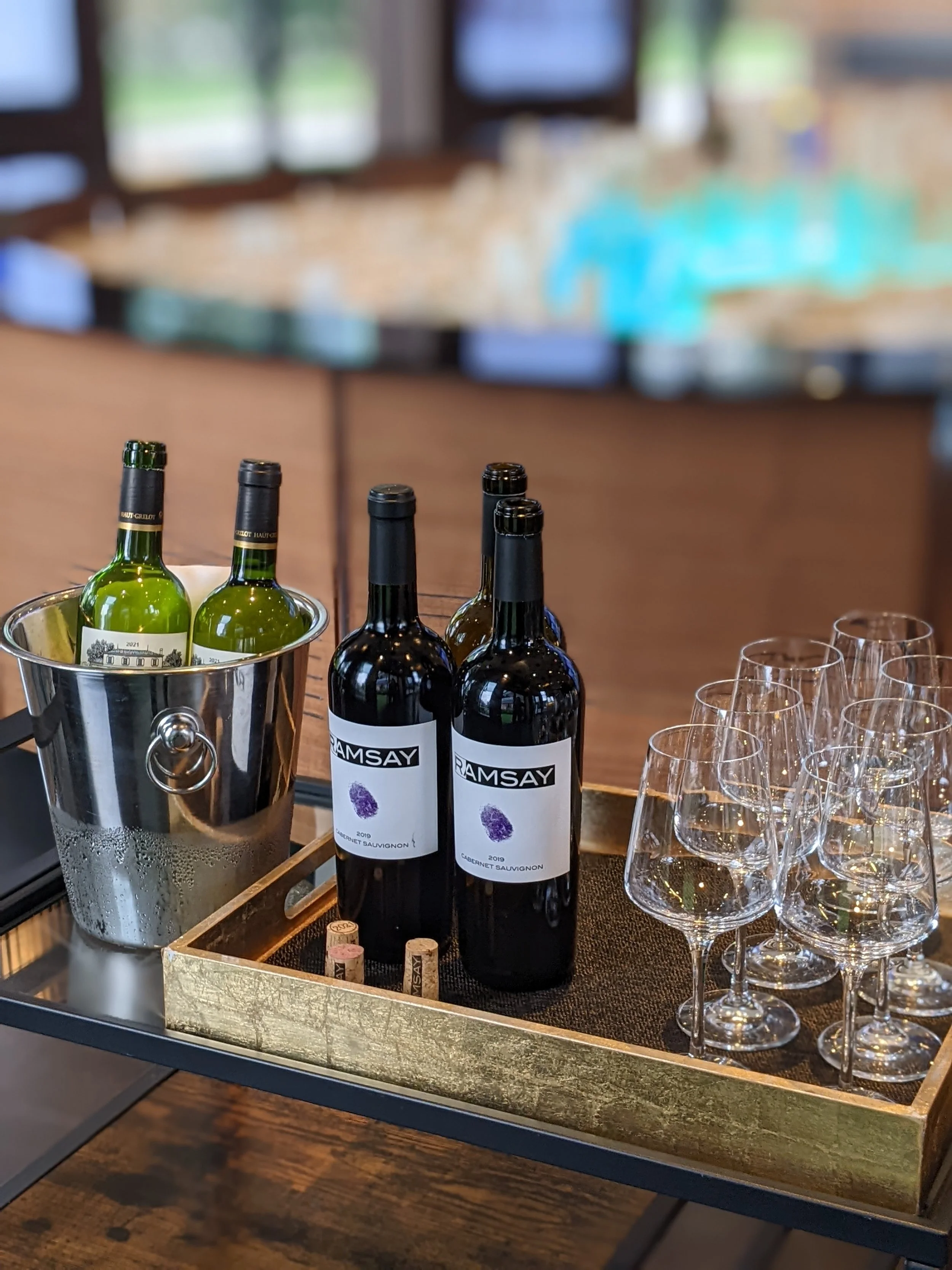 White wine in an ice bucket and red wine bottles ready for a wine tasting