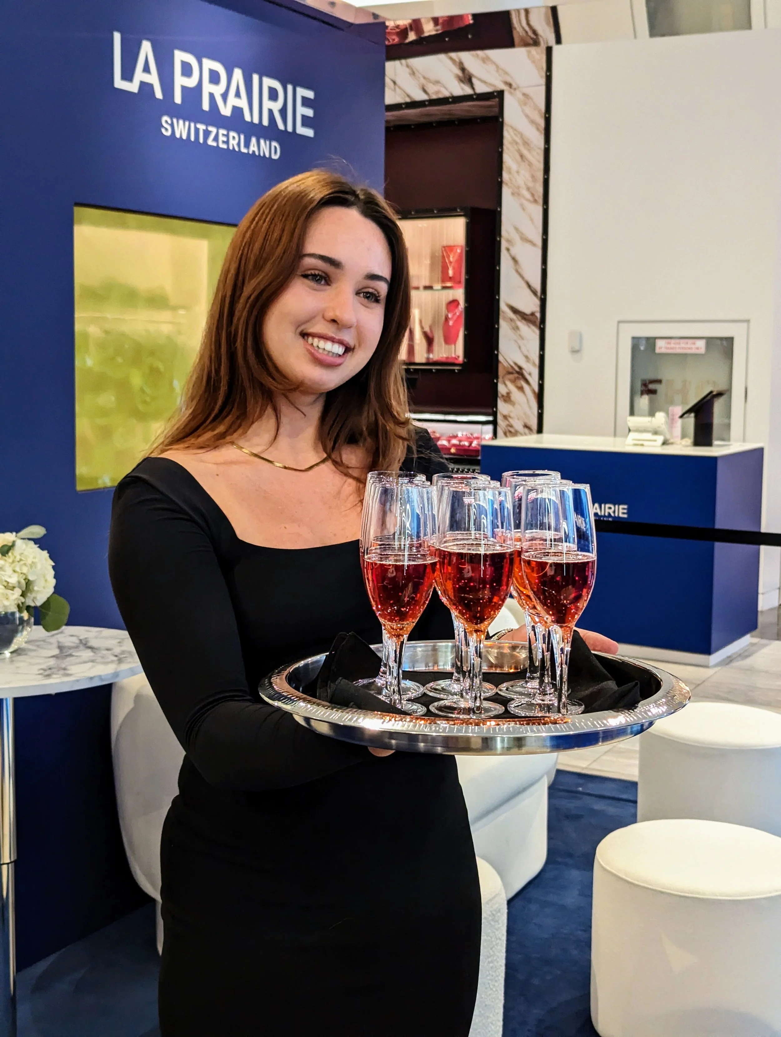 Server holding tray of champagne at a corporate event in Holt Renfrew Yorkdale